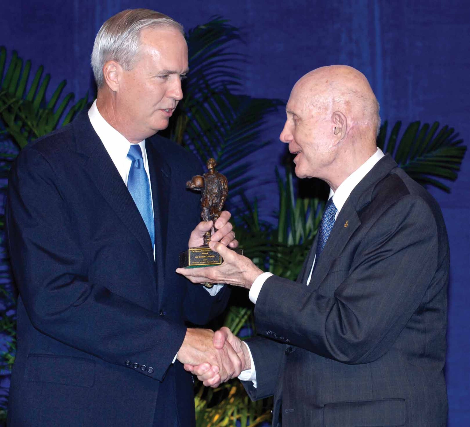 Robert Conner, left, accepts the first General Thomas P. Stafford Aerospace Award from the space pioneer Monday during ther Oklahoma Aerospace Summit and Expo in Oklahoma City.  (Air Force photo by Margo Wright)