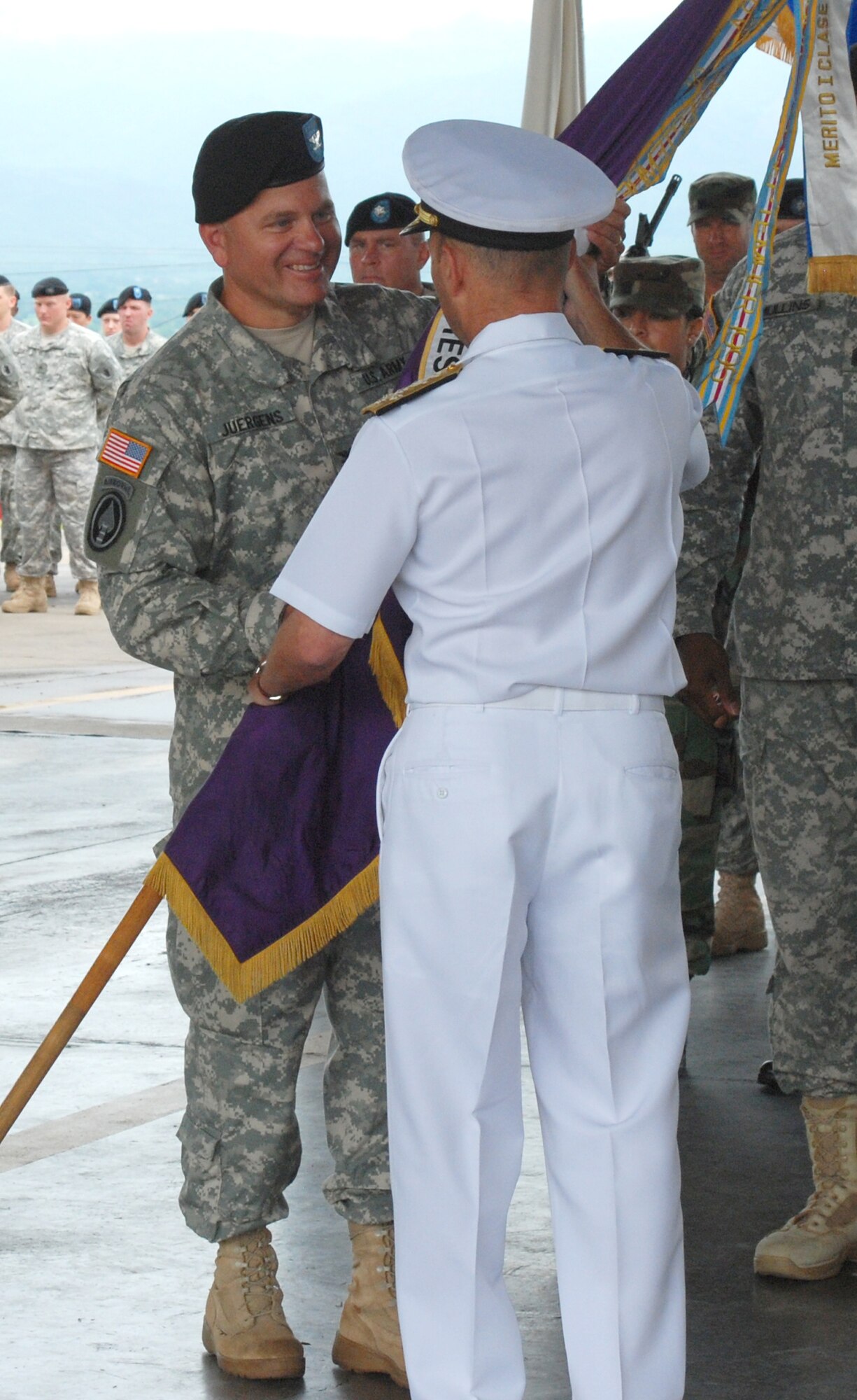 Col. Richard Juergens takes the Joint Task Force-Bravo unit colors from Adm. James Stavridis, commander of U.S. Souther Command, during a change of command ceremony June 27 at Soto Cano Air Base, Honduras. (Photo by Tech. Sgt. John Asselin) 