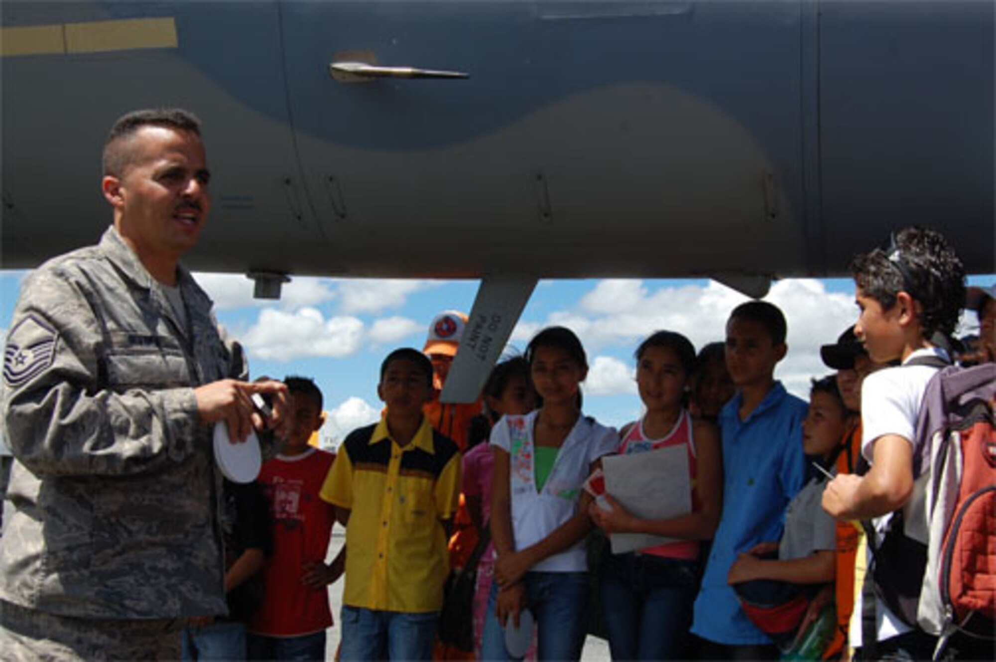 Master Sgt. Carlos Rivera, an F-15 crew chief with the 33rd Fighter Wing, gives a Spanish language tour of the F-15C Eagle for children of Fundaci?n El Man?, a local charitable organization focused on assisting disadvantaged children, at the RIO NEGRO air and trade show near Medellin Colombia.  Children from the non-profit organization, toured military aircraft before watching the F-15 West Coast Demonstration Team perform.  Afterwards, members of the team signed autographs and took photos with the VIP guests. (Photo by Capt. Nathan Broshear)