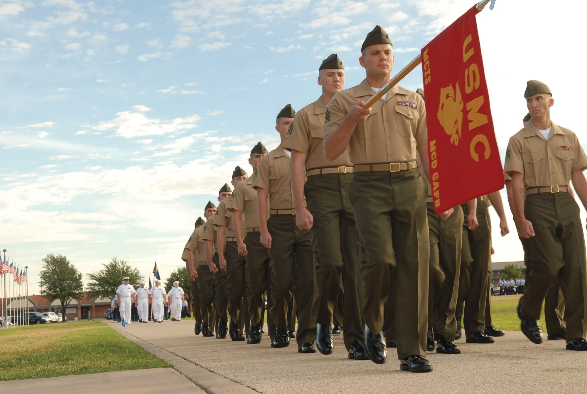Marines from the Goodfellow Marine Corps Detachment march in perfect step during the June 20 Pass in Review at the base parade field, followed by Sailors from the Center for Information Dominance Detachment. All four services represented on Goodfellow marched during the ceremony. Reveiwing official was Col. Ada Conlan, 17th Mission Support Group commander. (U.S. Air Force photo by Staff Sgt. John Barton)