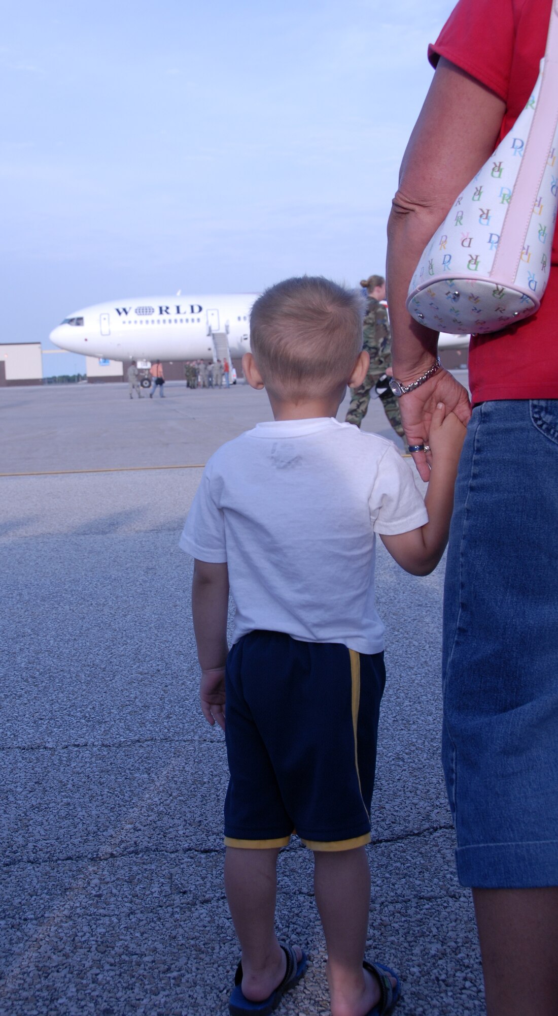 A small boy awaits the appearance of his deployed family member, an Air Force Reservist from the the 442nd Fighter Wing, at Whiteman Air Force Base, Mo., June 26, 2008.  Approximately 250 Citizen Airmen from the wing returned home to Whiteman from a 51-day deployment to Bagram Air Base, Afghanistan, in a contracted DC-10 aircraft.  (U.S. Air Force photo/Master Sgt. Bill Huntington)