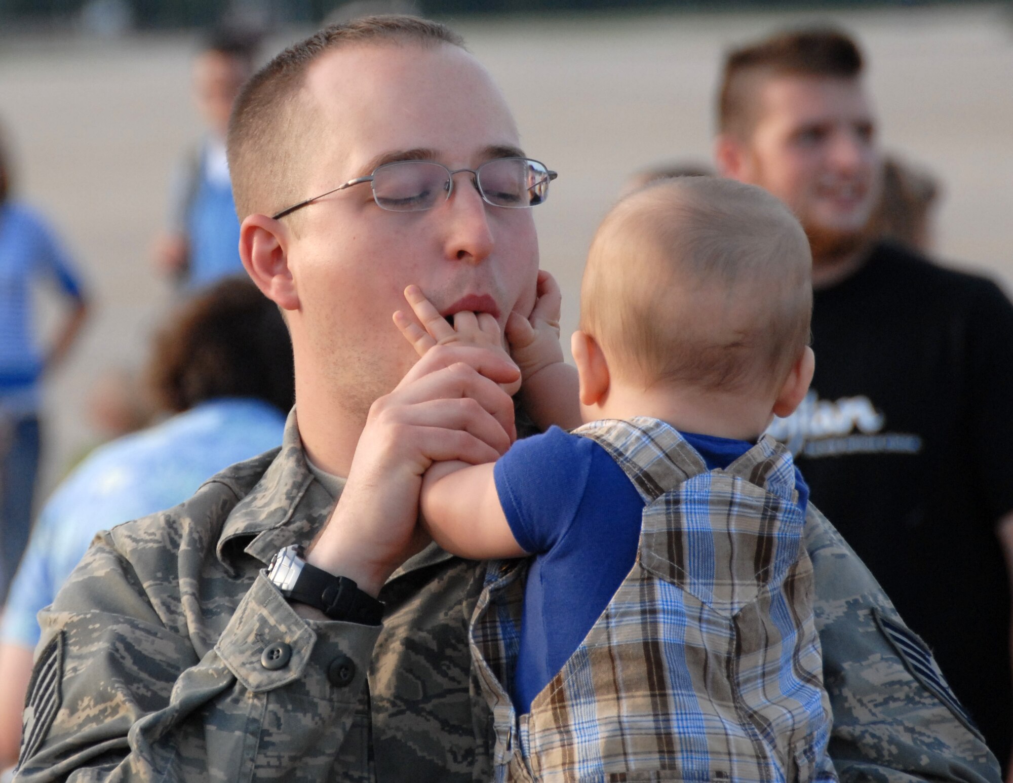 Tech. Sgt. Nicholas Norton greets a young family member upon his return from Afghanistan June 26, 2008, at Whiteman Air Force Base, Mo.  Sergeant Norton was one of approximately 250 Citizen Airmen from the 442nd Fighter Wing who returned from a 51-day deployment to Bagram Air Base, Afghanistan.  The reservists provided A-10 Thunderbolt II combat aircraft to support ground forces in Operation Enduring Freedom. Sergeant Norton is a member of the 442nd Maintenance Squadron's Munitions Flight.  (U.S. Air Force photo/Tech. Sgt. John Vertreese)