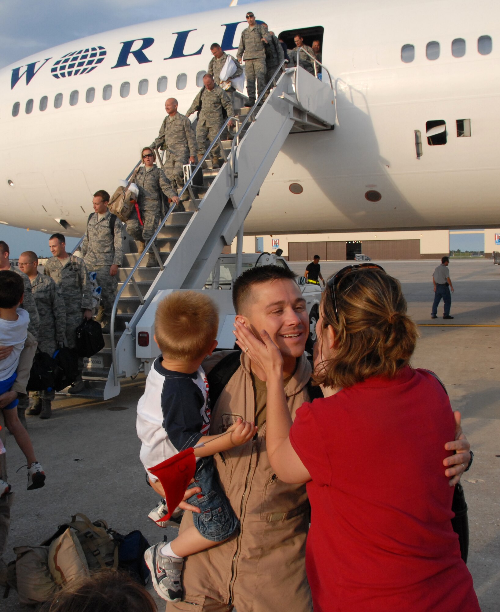 Maj. Todd Riddle embraces his family members following his return to Whiteman Air Force Base, Mo., after a deployment to Bagram Air Base, Afghanistan, June 26, 2008.  Approximately 250 Air Force Reservists from the 442nd Fighter Wing returned home following a 51-day deployment to provide A-10 Thunderbolt II ground-attack aircraft for Operation Enduring Freedom.  Major Riddle is an A-10 pilot in the wing's 303rd Fighter Squadron. (U.S. Air Force photo/Tech. Sgt. John Vertreese)