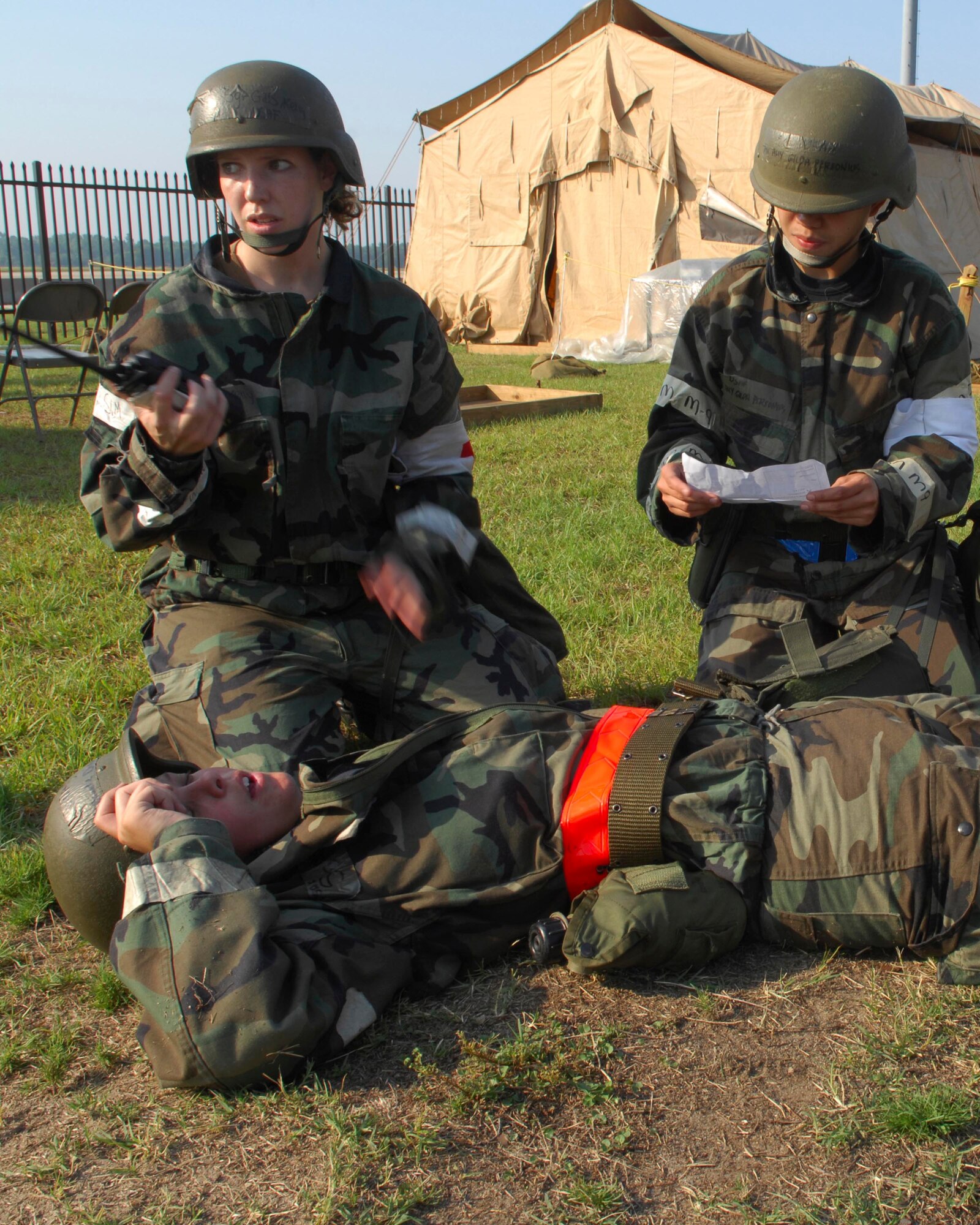 SHAW AIR FORCE BASE, S.C.-- Staff Sgt. Kelly Gills and Airman 1st Class Amy Personius, 20th Medical Group, call for medical assistance after discovering Staff Sgt. Brooke DiPasquale, 20th Medical Group, simulating a smoke inhalation emergency during a Phase II Operational Readiness Exercise June 25. Operational Readiness Exercises provide vital training and prepare Airmen for worldwide deployment. (U.S. Air Force photo/Senior Airman William Coleman)
