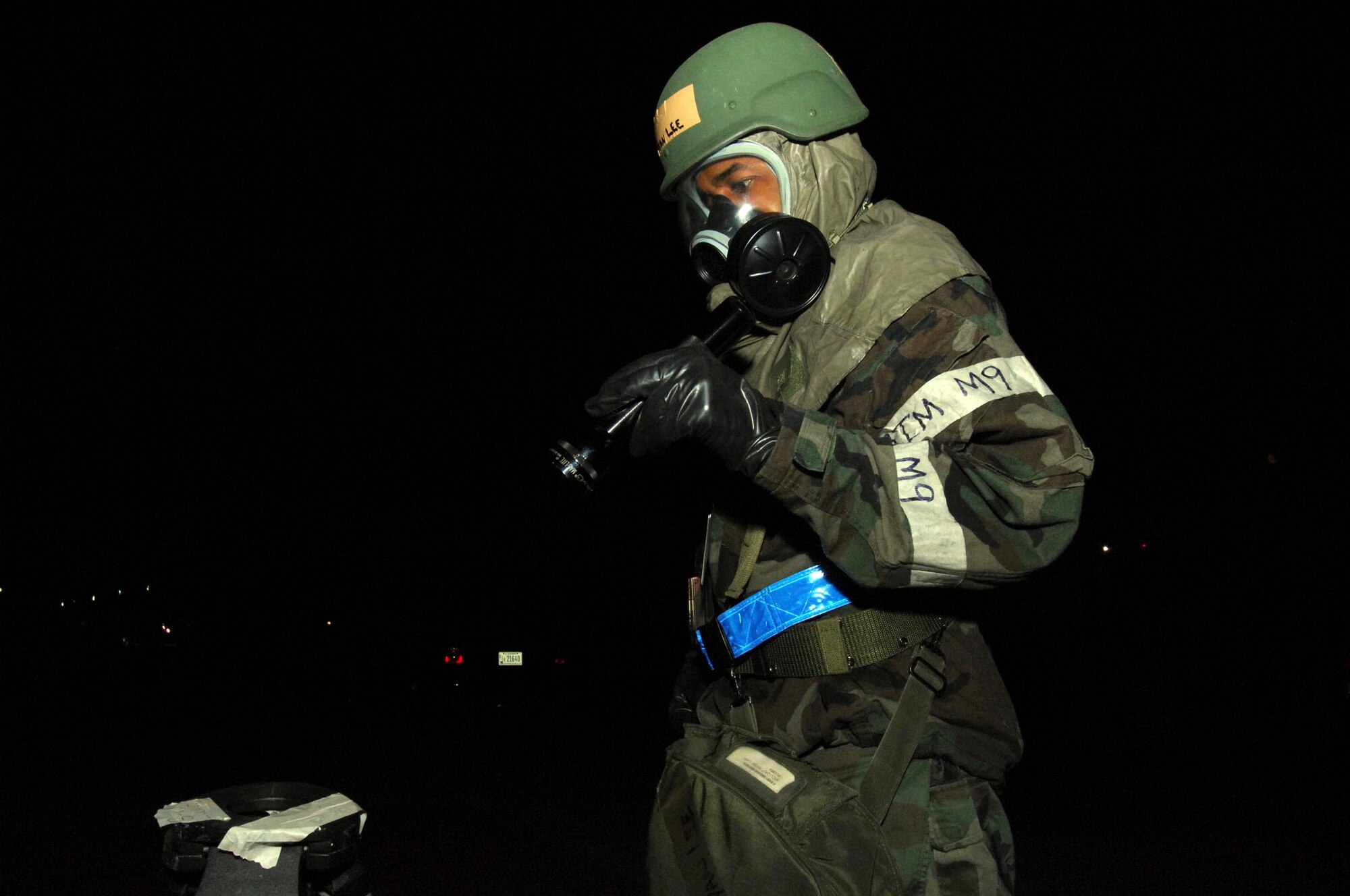 SHAW AIR FORCE BASE, S.C.-- Airman 1st Class Ryan Lee, 20th  Maintenance Group information manager journeyman, checks simulated M-8 paper for possible chemical agents during a Phase II Operational Readiness Exercise June 24.  Operational Readiness Exercises provide vital training and prepare Airmen for worldwide deployment. (U.S. Air Force photo/Senior Airman William Coleman)
