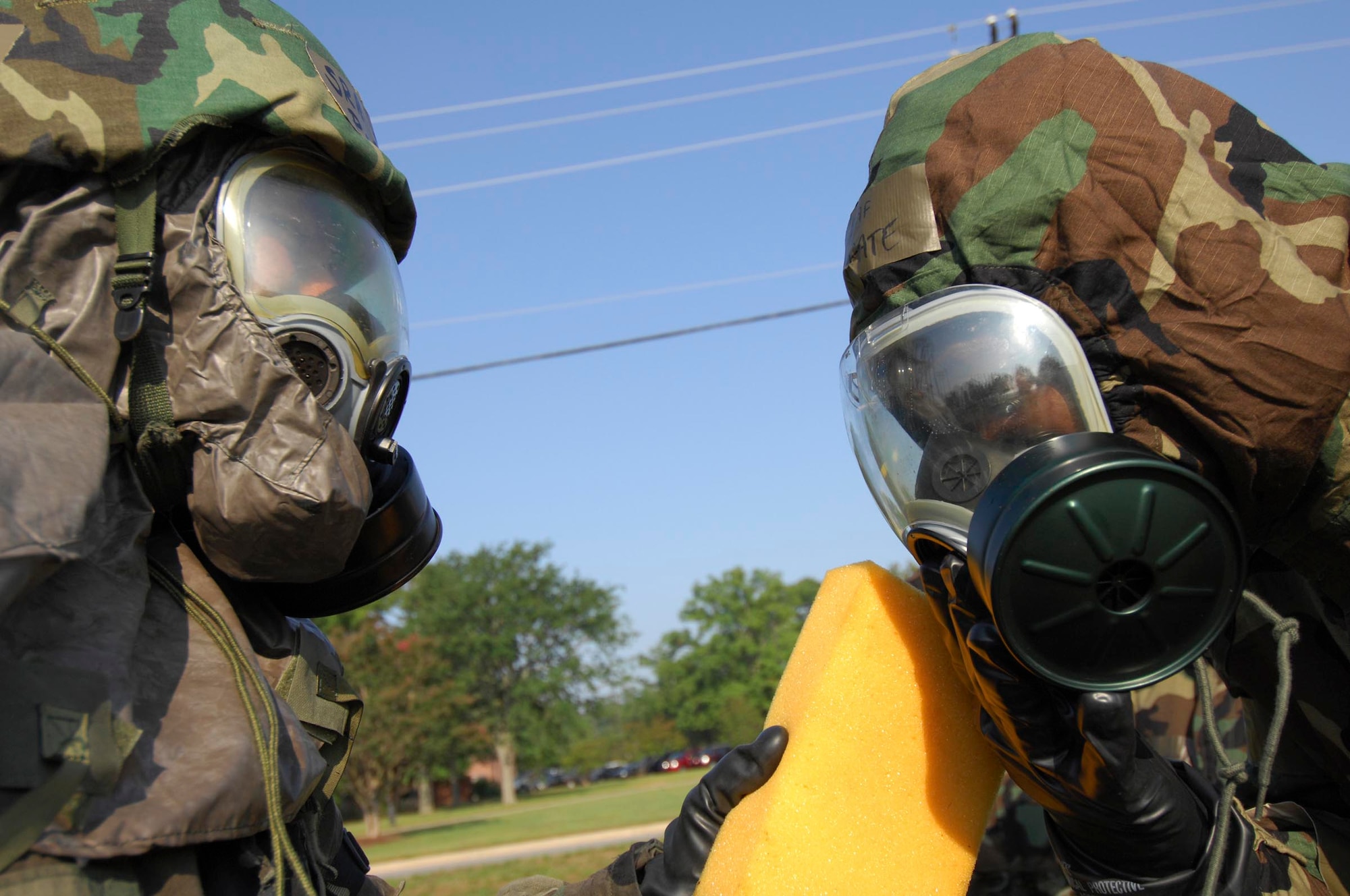 SHAW AIR FORCE BASE, S.C.--  Senior Airman Lawrence Porter, 20th Component Maintenance Squadron Aircraft Fuel Systems craftsman, performs a simulated decontamination on Chief Master Sgt. Lefford Fate, 20th Fighter Wing command chief, during a Phase II operational readiness exercise June 24. Operational Readiness Exercises provide vital training and prepare Airmen for worldwide deployment. (U.S. Air Force photo/SrA William Coleman)