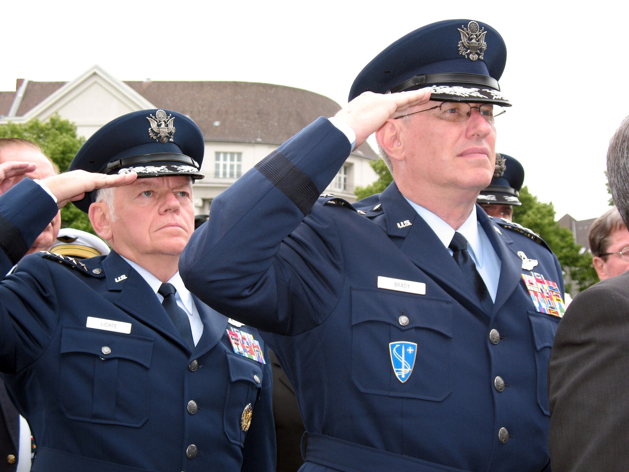 Gen. Arthur J. Lichte and Gen. Roger A. Brady salute during the playing of national anthems of the allied nations involved with the Berlin airlift June 27 in Berlin. The ceremony honored the 78 fallen airmen who lost their lives during the Berlin Airlift. General Lichte is the commander of Air Mobililty Command, and General Brady is the U.S. Air Forces in Europe commander. (U.S. Air Force photo/Master Sgt. Ron Przysucha)