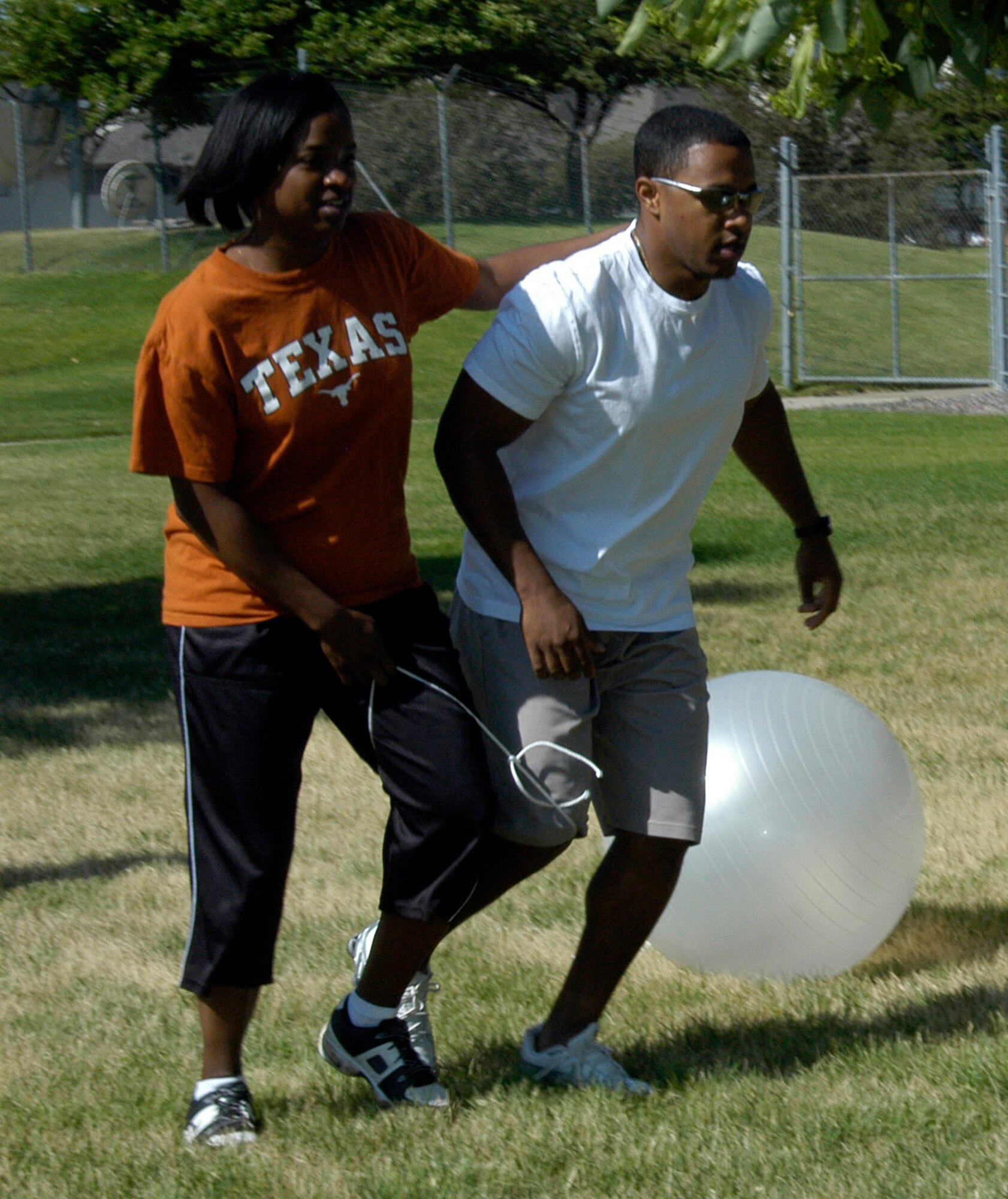 Tech. Sgt. Joniece Jackson and Capt. Eric Patterson, both of DPX, participate in the three-legged race during the ARPC obstacle course June 27. The event raised $140 toward the ARPC summer picnic. The winning team was the DPB team of: Staff Sgts. Damien Pierce, Jason Burbach and Ramon Montoya, and Senior Airman Jason Mendoza. (U.S. Air Force photo/Mike Molina)