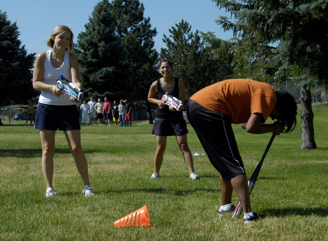 Tech. Sgt. Jessica Cook (left) and Staff Sgt. Annicah Diaz, both of DPA, squirt Tech. Sgt. Joniece Jackson, DPX, as she participates in the ARPC obstacle course June 27. The event raised $140 toward the summer picnic. The winning team was the DPB team of: Staff Sgts. Damien Pierce, Jason Burbach and Ramon Montoya, and Senior Airman Jason Mendoza. (U.S. Air Force photo/Mike Molina)