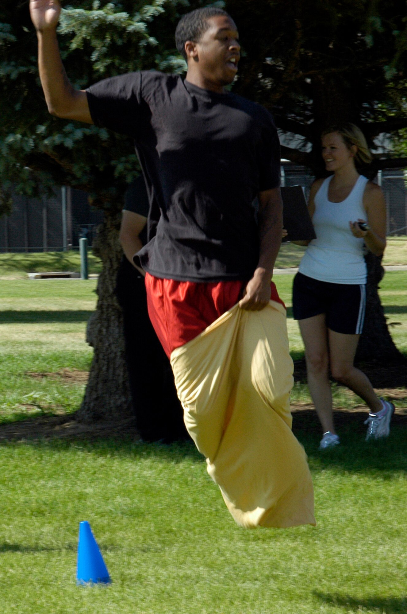 Airman 1st Class Sancoyus Justice, DPS, gets some air during the sack race at the ARPC obstacle course June 27. The event raised $140 toward the ARPC summer picnic. The winning team was the DPB team of: Staff Sgts. Damien Pierce, Jason Burbach and Ramon Montoya, and Senior Airman Jason Mendoza. (U.S. Air Force photo/Mike Molina)                           
