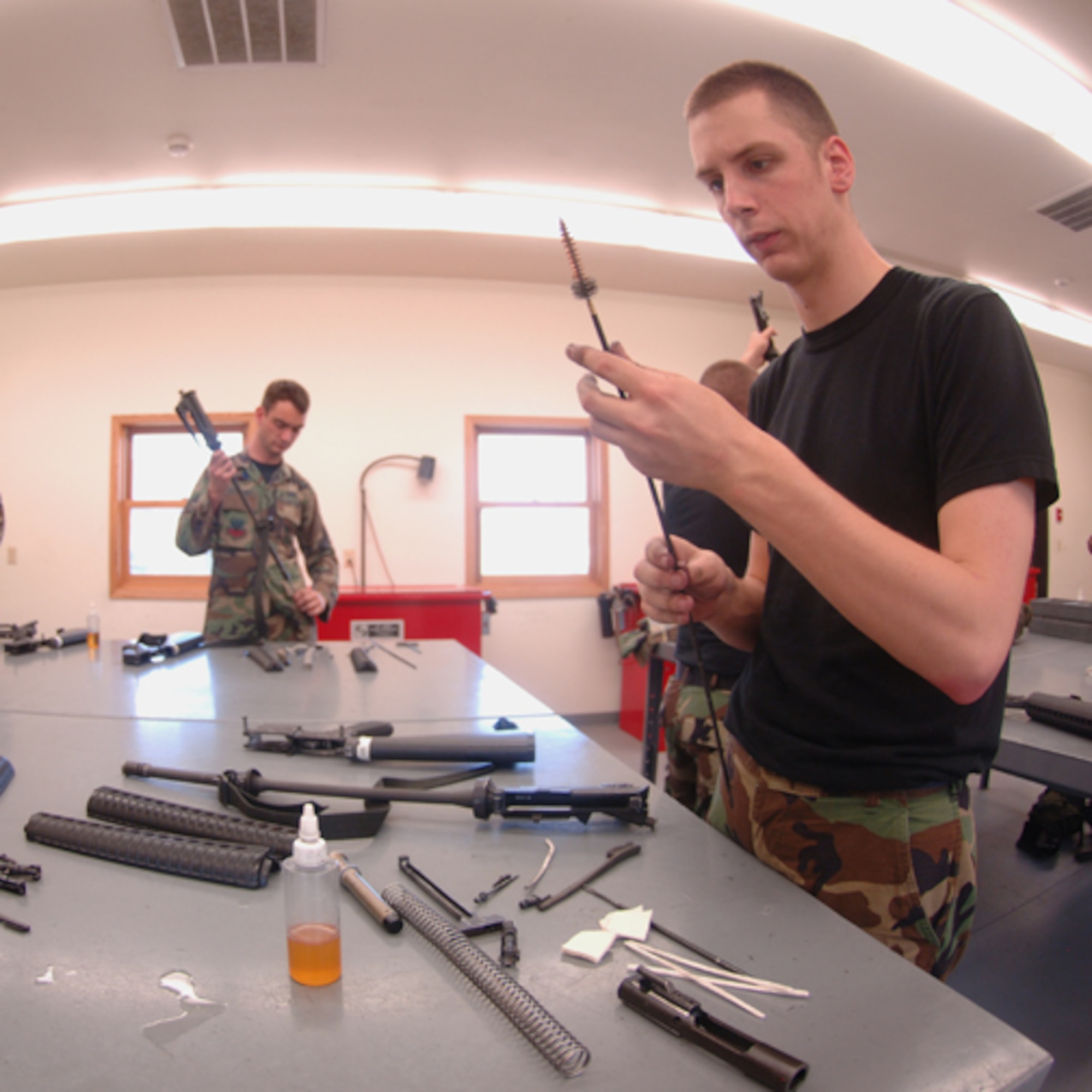 MINOT AIR FORCE BASE, N.D. -- Airman 1st Class Gregory Gilmer, 5th Comptroller Squadron, cleans an M-16 rifle during augmentee training here June 25. Augmentees are volunteer Airmen from a wide variety of Air Force career fields who assist the 5th Security Forces Squadron by performing base security duties; enabling regular SFS personnel to perform other roles in support of air base defense. Augmentees are given specialty training in weapons, possible scenarios, rules of engagement and use of force. (U.S. Air Force photo by Airman 1st Class Sharida Bishop)