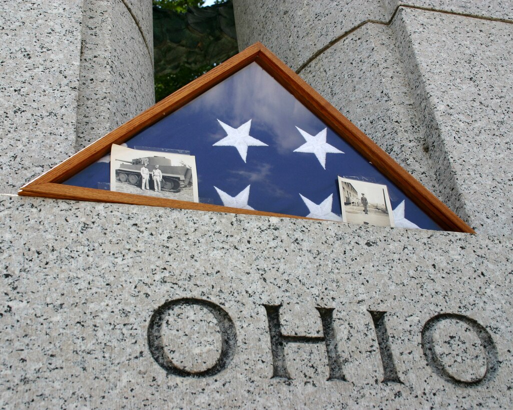 A flag honoring the late Robert Limpf, a World War II veteran from Toledo, Ohio, is displayed June 25 over the state's portion of the World War II Memorial in Washington, D.C. The flag was brought to the memorial by familiy members who were part of a delegation of World War II veterans and their families from the Honor Flight organization. The photos inside the frame are of the Mr. Limpf during his service in Europe as part of the 786th Tank Battalion. (U.S. Air Force photo/Senior Master Sgt. Raymond Sarracino) 