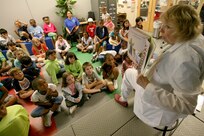 6/16/2008 - Alice Serafin reads "How Do Dinasaurs Eat Their Food?" to second and third graders at the Lackland Youth Center during the kickoff to the summer reading program.  This year's theme is Back to the Future and runs until July 31. The program moves from dinosaurs in the prehistoric past to an alien visitor's party. For more information, call the library at 671-3610.
(Photo by Robbin Cresswell)

