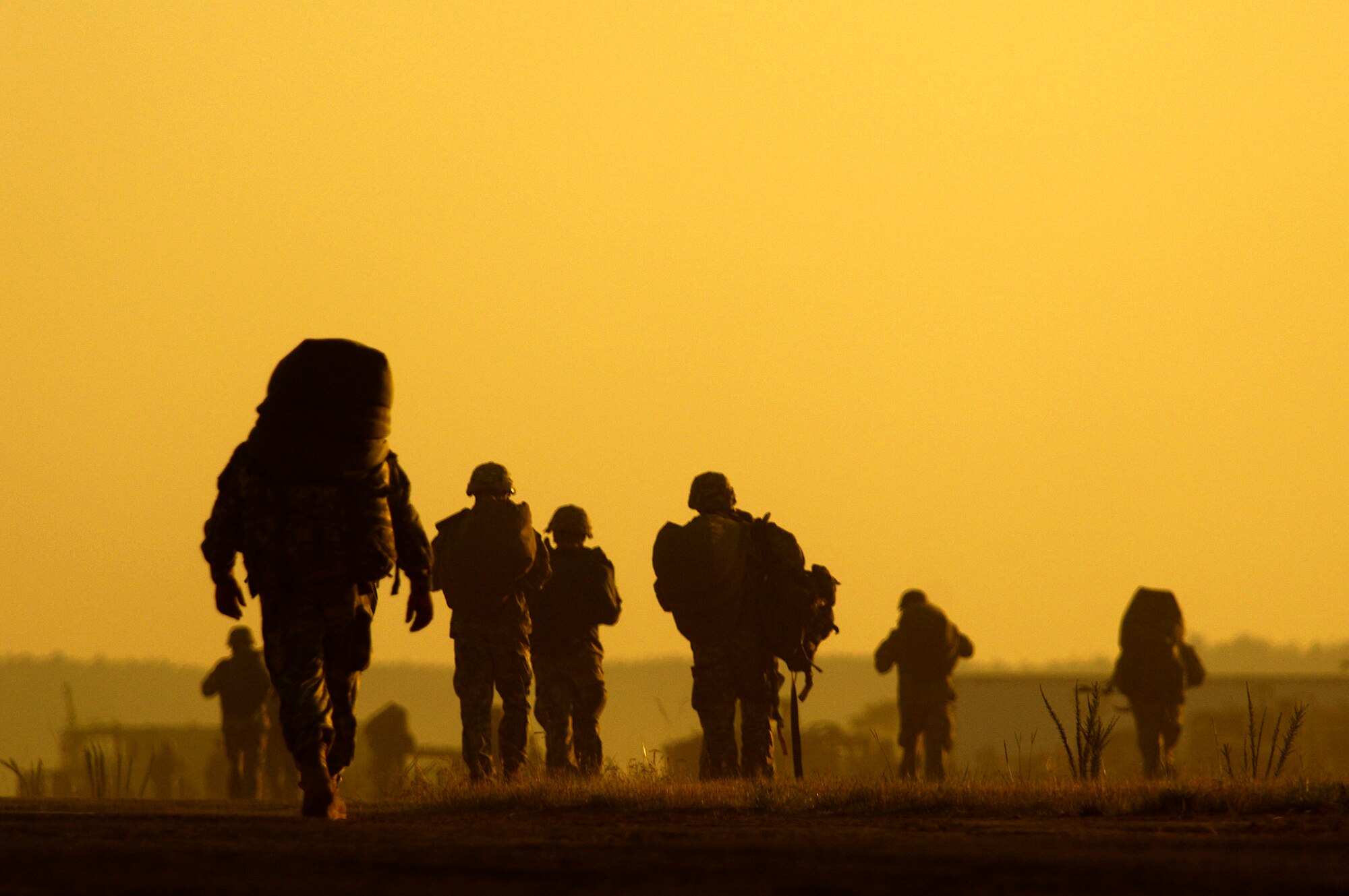 Paratroopers from the 82nd Airborne Division move toward a rally point after jumping from a C-17 Globemaster III during Joint Forcible Entry Exercise June 18 at Fort Bragg, N.C. The exercise is a joint airdrop exercise designed to enhance service cohesiveness between Army and Air Force members, allowing both services an opportunity to properly execute large-scale heavy equipment and troop movement. (U.S. Air Force photo/Staff Sgt. Jacob N. Bailey)