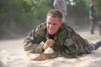 6/11/2008 - Air Force Academy Cadet 3rd Class Stephen Vrabic low crawls through an obstacle at the basic military training obstacle course during Lackland's Summer Leadership Program.  
(USAF photo by Robbin Cresswell)