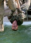 6/11/2008 - Air Force Academy Cadet 3rd Class Zach Bradford navigates a water obstacle at the basic military training obstacle course.  Cadet Bradford is taking part in Lackland's Summer Leadership Program to observe how military training instructors turn a flight of approximately 50 trainees into a team.
(USAF photo by Robbin Cresswell)