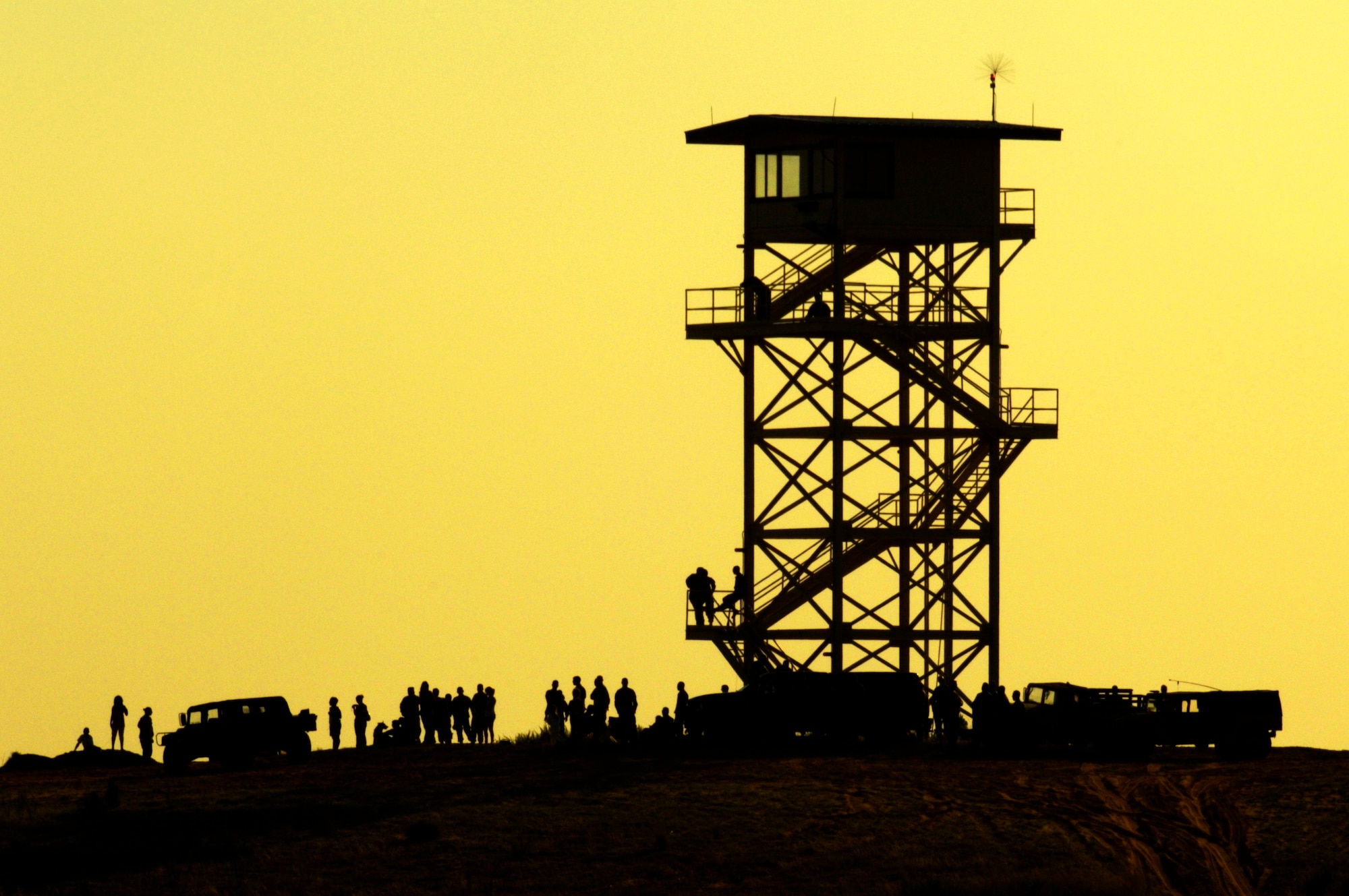 82nd Airborne Division Soldiers gather to watch a personnel drop during Joint Forcible Entry Exercise June 18 at the Holland Drop Zone at Fort Bragg, N.C. The exercise is a joint airdrop exercise designed to enhance service cohesiveness between Army and Air Force members, allowing both services an opportunity to properly execute large-scale heavy equipment and troop movement. (U.S. Air Force photo/Staff Sgt. Jacob N. Bailey) 