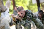 6/11/2008 - Air Force Academy Cadet 3rd Class Matthew Thomas navigates an obstacle at the basic military training obstacle course.  Cadet Thomas is taking part in Lackland's Summer Leadership Program to observe how military training instructors turn a flight of approximately 50 trainees into a team.
(USAF photo by Robbin Cresswell)