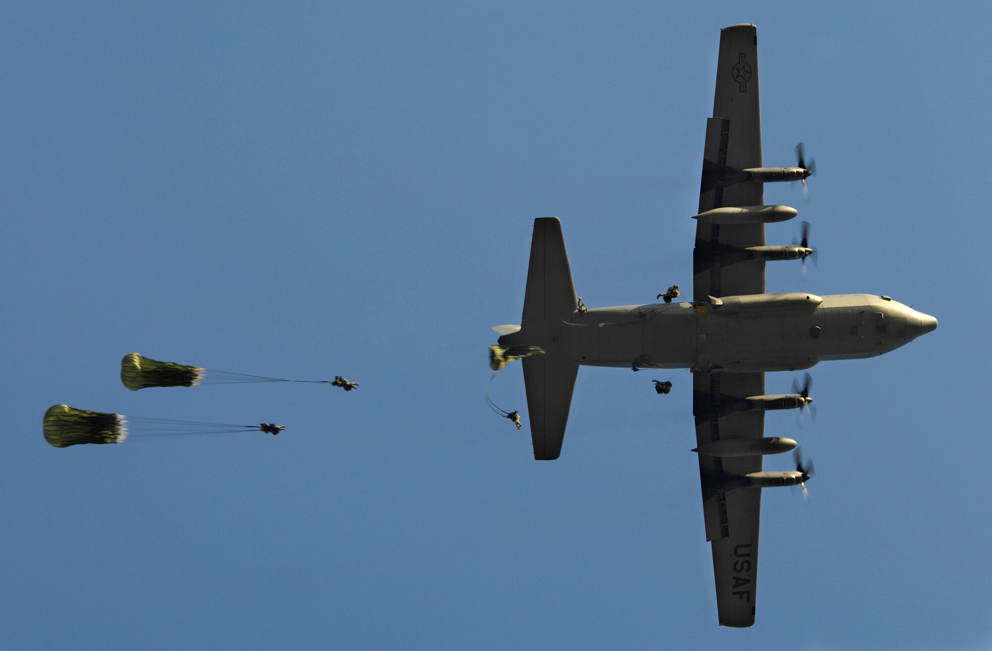 Paratroopers from the 82nd Airborne Division jump from a C-130 Hercules during Joint Forcible Entry Exercise June 18 at Fort Bragg, N.C. The exercise is a joint airdrop exercise designed to enhance service cohesiveness between Army and Air Force members, allowing both services an opportunity to properly execute large-scale heavy equipment and troop movement. (U.S. Air Force photo/Staff Sgt. Jacob N. Bailey) 