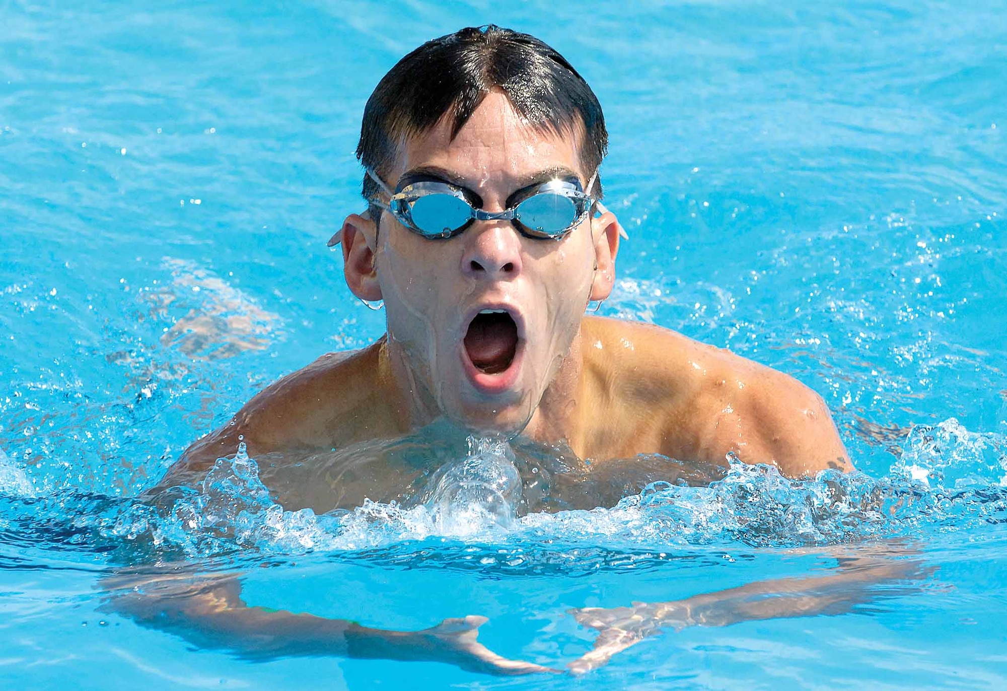 Staff Sgt. Michael Nicholl, 552nd Maintenance Group, surfaces briefly during a 500-meter swim at the Gerrity Fitness Center June 19, pushing himself during an Air Force pararescue  and combat control recruiting stop.  More than 20 men took the physical evaluation tests, many with dreams of wearing the elite red or maroon berets.  (Air Force photo by Margo Wright