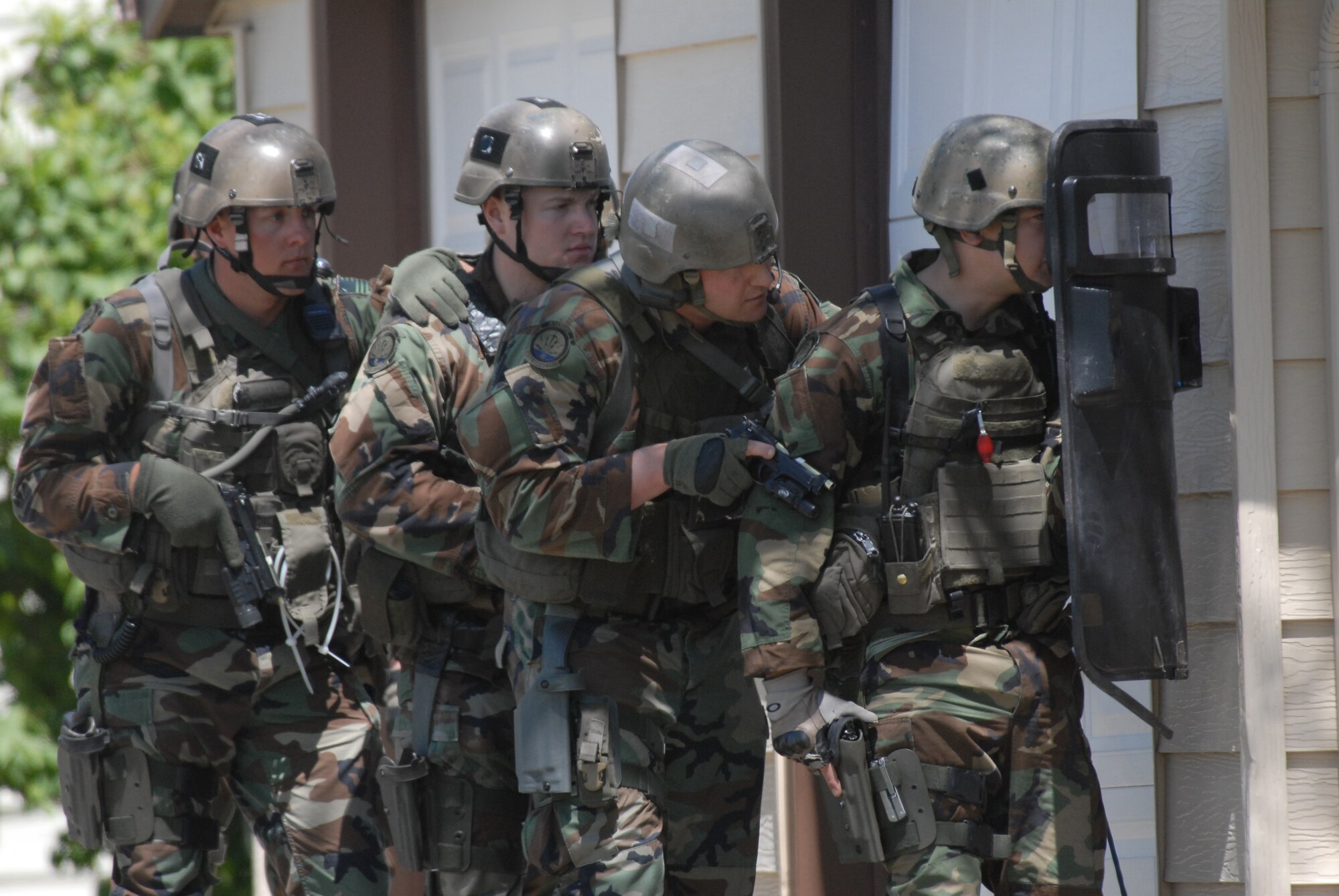 Members of the 341st Security Forces Group tactical response force assault team prepare to snatch-and-grab a hostage during an exercise in base housing June 23. (U.S. Air Force photo/John Turner)