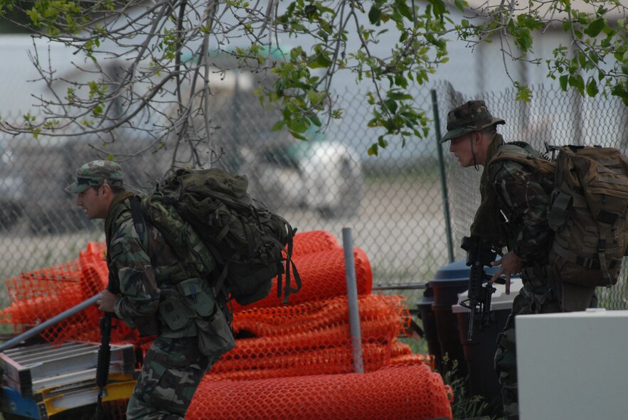 Airman 1st Class Ryan Krastins and Senior Airman William Briggs, 341st Security Forces Group tactical response force close precision engagement overwatch team, moving into their overwatch position during an exercise June 23. The exercise consisted of responding to a hostage situation in the housing area on base. (U.S. Air Force photo/John Turner)