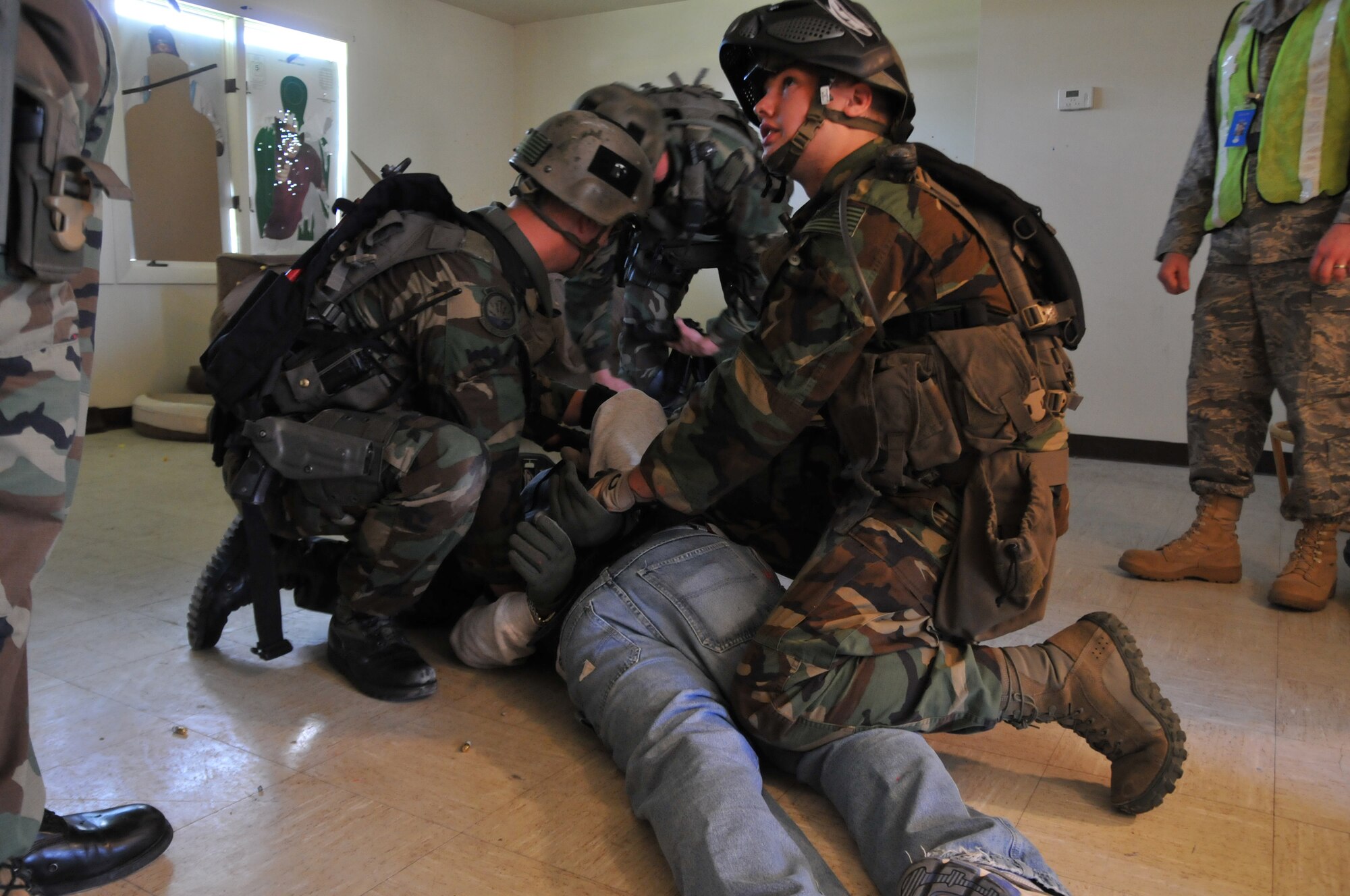 Senior AIrman Ryan Link, 341st Security Forces Group tactical response force, secures a suspect on the scene during an exercise held June 23. The exercise consisted of responding to a hostage situation in the housing area on base. (U.S. Air Force photo/John Turner)