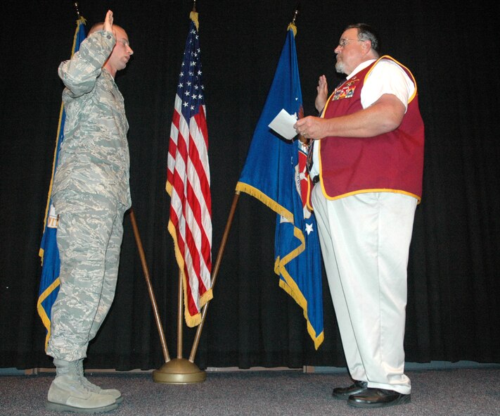 Retired Capt. Bill Robinson administers the oath of enlistment to Master Sgt. Robert Todd, Airey NCO Academy superintendent of plans and programs, during a ceremony at the academey here Monday.  (U.S. Air Force photo/Staff Sgt. Timothy R. Capling)