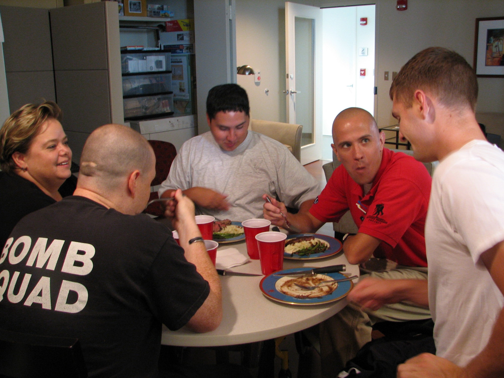 Annette Slaydon (from left to right), Staff Sgt. Matt Slaydon, Airman 1st Class Kevin Krogh, Chris Ebner, and Marine Cpl. Travis Dodson enjoy a meal at the Center for the Intrepid June 24 in San Antonio. The lunch was prepared by Tech. Sgt. Jason Simas and Staff. Sgt. Michael Leo. The sergeants are enlisted aides to the Air Education and Training Command commander and vice commander. They volunteered their culinary talents to support Airmen and others at the Center for the Intrepid. (U.S. Air Force photo/Beverly Simas) 
