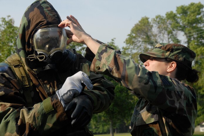 Staff Sgt. Kandice Caputo checks the seal on Staff Sgt. Justin Steidler's gas mask while wearing mission-oriented protective posture gear during a chemical, biological, radiological, nuclear explosive scenario June 24 on Charleston AFB. Airmen from across the base are participating in a mobility exercise in preparation for the operational readiness inspection in August. Sergeant Caputo is the 437th Civil Engineer Squadron NCO in charge of emergency management training and Sergeant Steidler is a 437th Medical Group medical material craftsman. (U.S. Air Force photo/Airman 1st Class Cynthia Spalding) 