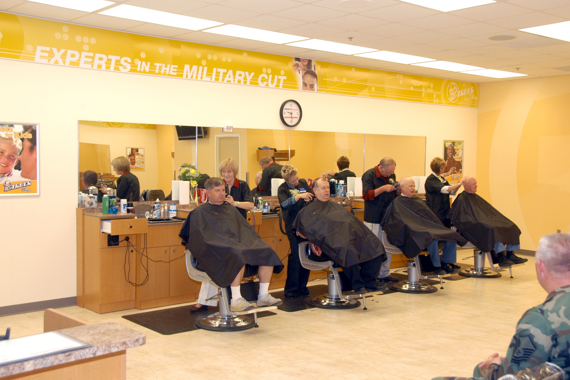 Team Offutt members enjoy the larger barber shop in the base exchange mall. The mall area includes a larger food court, clothing sales, GNC and more.  (U.S. Air Force Photo By/Jeff Gates)