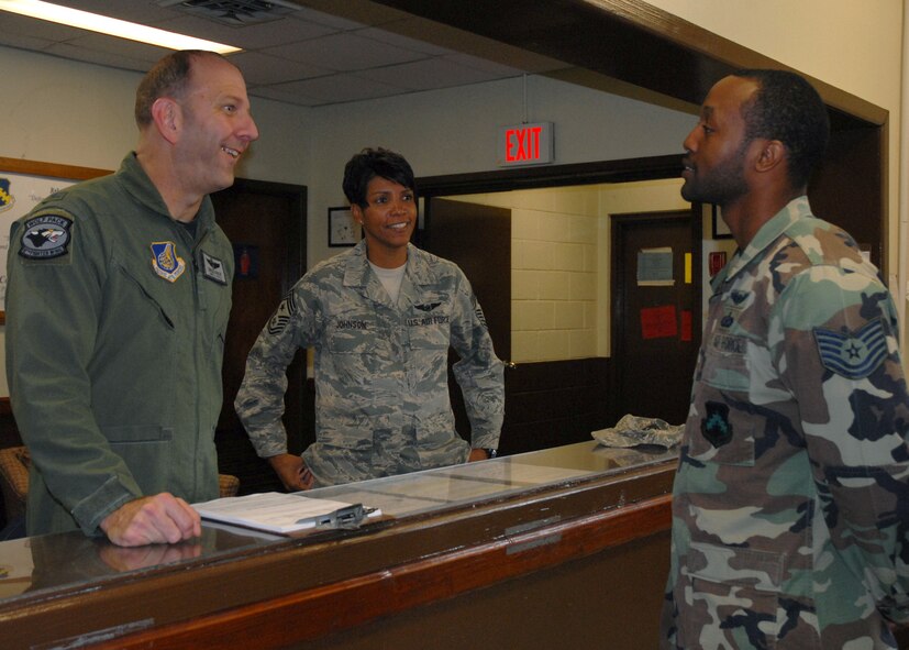KUNSAN AIR BASE, Republic of Korea—Colonel Greig "Wolf 2" Rice, 8th Fighter Wing vice commander and Chief Master Sergeant Cathy "Wolf Chief" Johnson, 8th Fighter Wing command chief master sergeant congratulate Tech. Sgt. Quinton Burris, 8th Fighter Wing Public Affairs, on his promotion to master sergeant here June 27. With the switch to all-electronic notification, Kunsan leaders still personally recognize their Airmen selected for promotion. (U.S. Air Force Photo/Staff Sgt Araceli Alarcon)