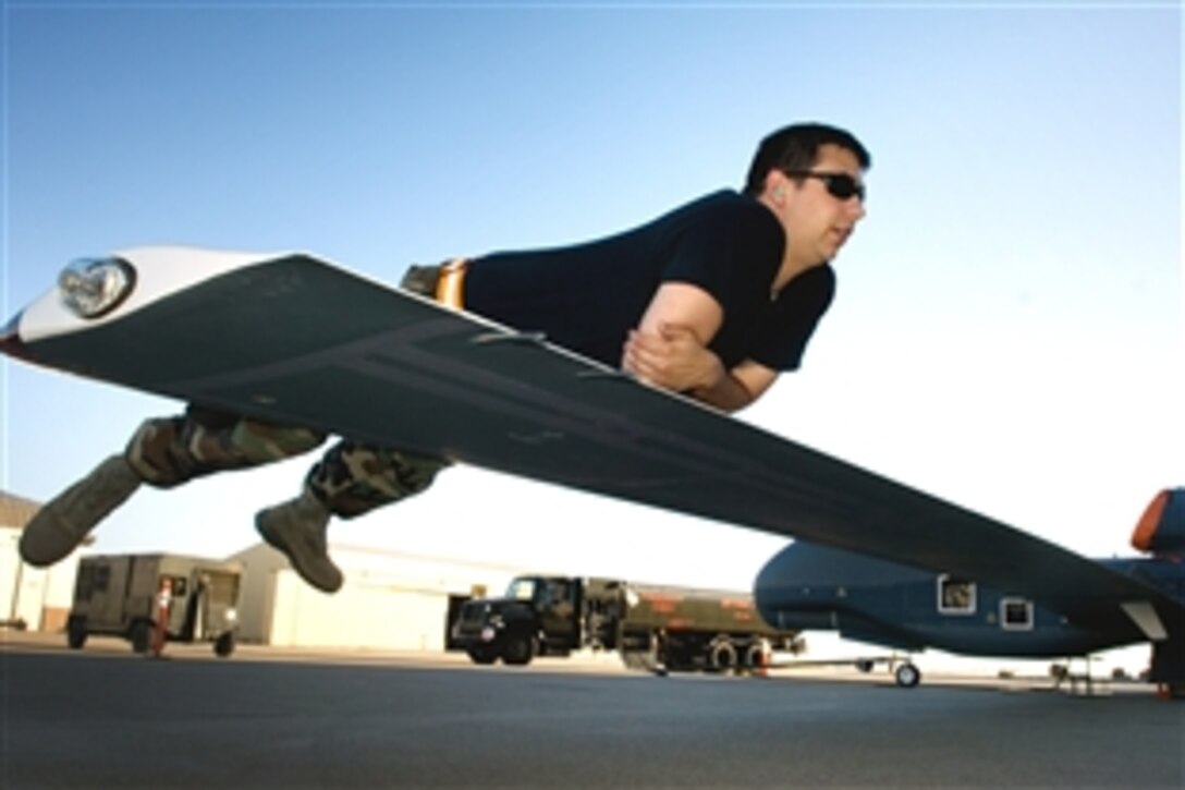 U.S. Air Force Senior Airman Jacob Hush serves as the counterbalance as fuel is pumped into a RQ-4 Global Hawk at Beale Air Force Base, Calif., June 16, 2008. 