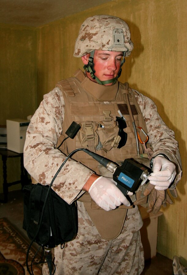 During an occupied house search exercise here June 27, 2008, Lance Cpl. Anthony Romberger, an Company E, 2/25 fire team leader from Harrisburg, Pa., learns to operate a Fido sensor device to detect explosive chemical materials used to build bombs and improvised explosive devices.  The Fido is widely utilized by military and civilian law enforcement agencies.