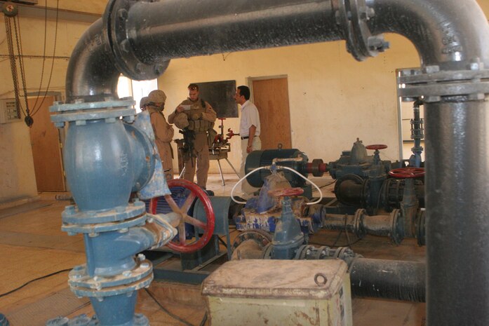 2nd Lt. Dan J. Alldridge, officer in charge, Detachment 1, Civil Affairs Team 4, 2nd Battalion, 11th Marine Regiment, Regimental Combat Team 5, talks with the manager of the water treatment facility in Rutbah, Iraq, June 27. Marines with CA Team 4 inspected the pump house to see about putting in a generator that would free the pump house from being dependant on the national power grid. The power grid is not consistent and due to lack of power, the water facility is not able to operate at maximum potential.::r::::n::