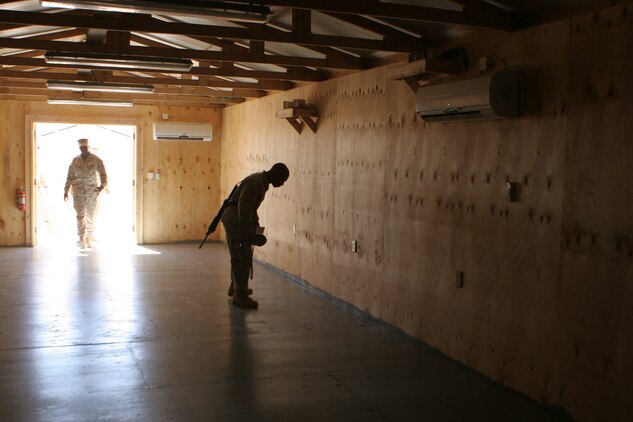 COP RAWAH, Iraq (June 27, 2008) ? Sgt. Maj. Wayne O. Gallman, battalion sergeant major, Combat Logistics Battalion 6, 1st Marine Logistics Group, walks through the doorway of a newly built medical facility. This new structure will provide improved sanitary conditions for medical personnel to work in. Gallman and Lt. Col. David J. Eskelund, battalion commander, CLB-6, toured seven locations that CLB-6 operates from to speak face-to-face with their Marines and check on the improvements of projects being built. The tour included stops at Korean Village, al-Qaim, Haditha Dam, Gannon II, Tripoli, Rawah and Anah. (Photo by Lance Cpl. Robert C. Medina)