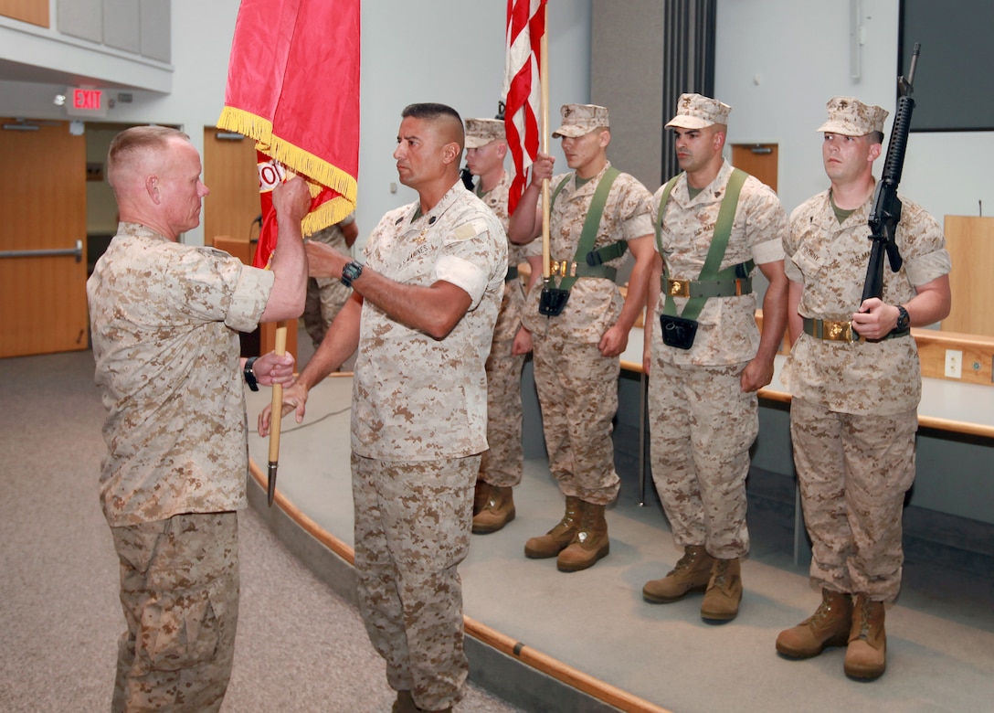 Brig. Gen. Larry D. Nicholson, left, receives the organizational colors of 2nd Marine Expeditionary Brigade from Sgt. Maj. Ernest K. Hoopii during the change of command ceremony for the MEB where Nicholson relinquished command of the unit to Maj. Gen. John E. Wissler aboard Camp Lejeune, N.C., May 21, 2010.  Nicholson and Hoopii led the MEB during its deployment to Afghanistan's Helmand province.