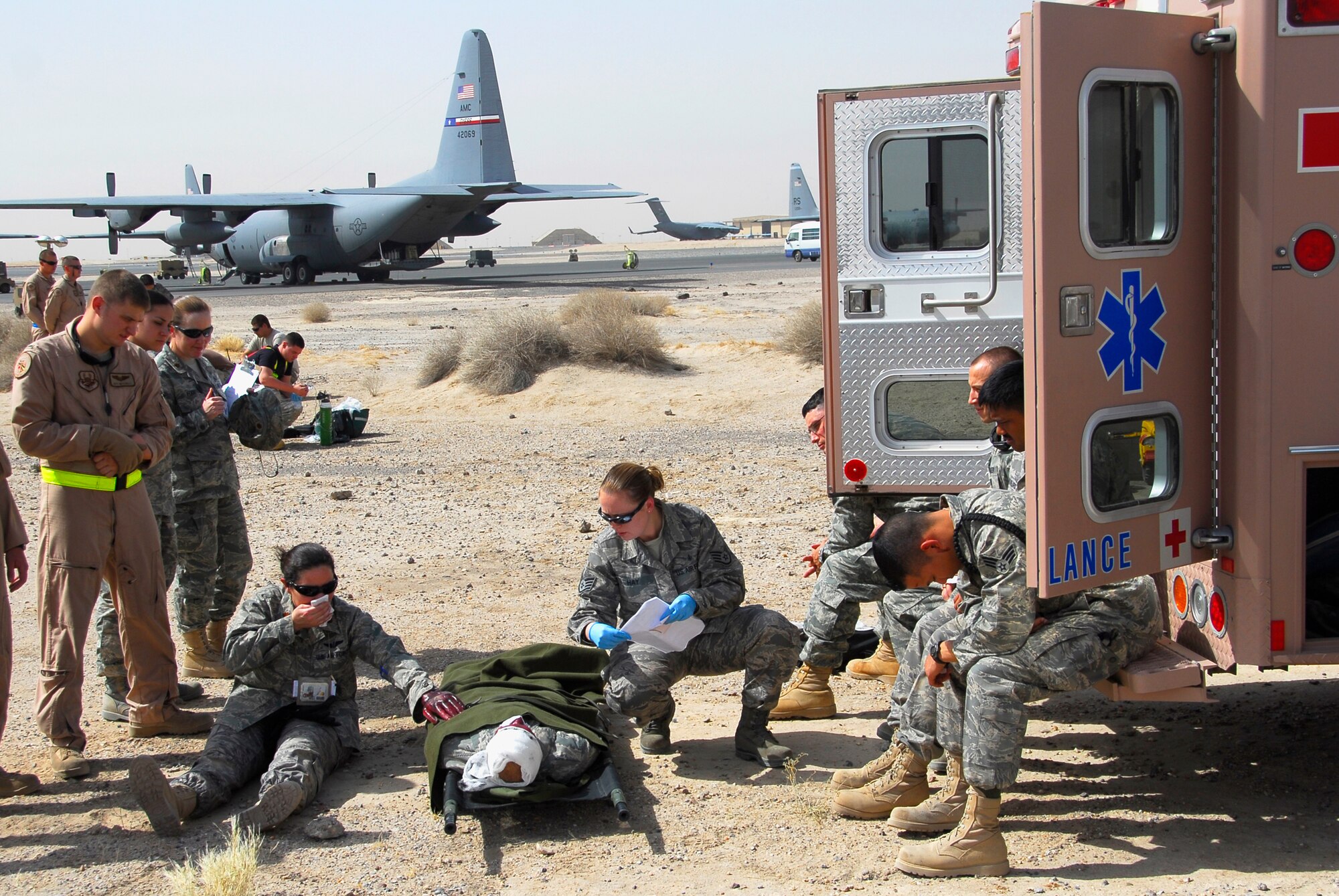 SOUTHWEST ASIA -- Staff Sgt. Sara Hay, (wearing blue gloves), an independent duty medical technician deployed to the 386th Expeditionary Medical Group, cares for a seriously ill patient and multiple lesser injured patients June 26, 2008, during a major accident response exercise at an air base in the Persian Gulf Region. She is aiding in the staging and treatment of victims who will need transport for further treatment. The purpose of the MARE is to evaluate the Wing's ability to respond to and recover from an aircraft mishap and mass casualty incident. (U.S. Air Force photo/ Staff Sgt. Patrick Dixon)