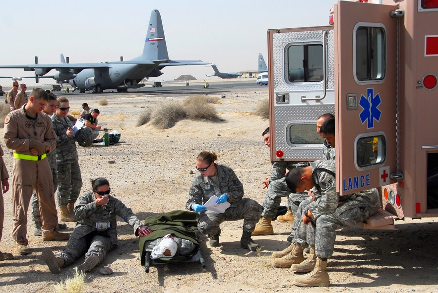 SOUTHWEST ASIA -- Staff Sgt. Sara Hay, (wearing blue gloves), an independent duty medical technician deployed to the 386th Expeditionary Medical Group, cares for a seriously ill patient and multiple lesser injured patients June 26, 2008, during a major accident response exercise at an air base in the Persian Gulf Region. She is aiding in the staging and treatment of victims who will need transport for further treatment. The purpose of the MARE is to evaluate the Wing's ability to respond to and recover from an aircraft mishap and mass casualty incident. (U.S. Air Force photo/ Staff Sgt. Patrick Dixon)