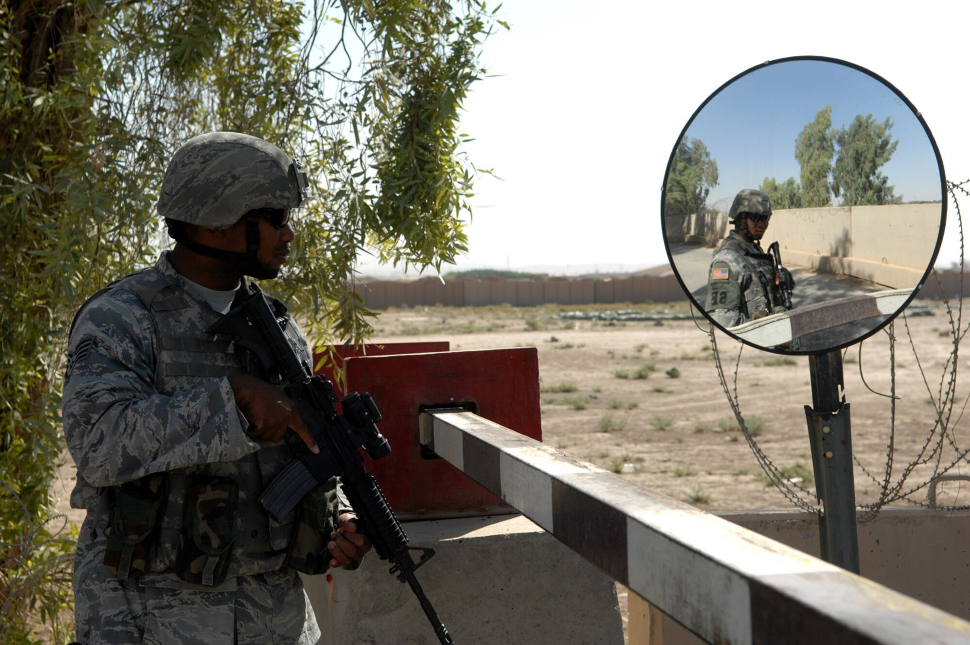 KIRKUK REGIONAL AIR BASE, Iraq – Staff Sgt. Mario Ferguson, 506th Expeditionary Security Forces Squadron, stands guard at an entry control gate recently here. Sergeant Ferguson is deployed here from Homestead Air Reserve Base, Fla., and is a Miami native. (U.S. Air Force photo by Senior Airman SerMae Lampkin)