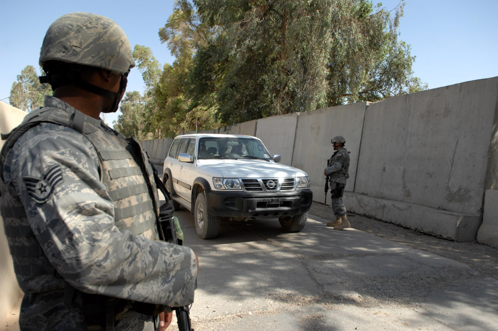 KIRKUK REGIONAL AIR BASE, Iraq – Staff Sgt. Mario Ferguson, 506th Expeditionary Security Forces Squadron, stands guard at an entry control gate recently here. Sergeant Ferguson is deployed here from Homestead Air Reserve Base, Fla., and is a Miami native. (U.S. Air Force photo by Senior Airman SerMae Lampkin)