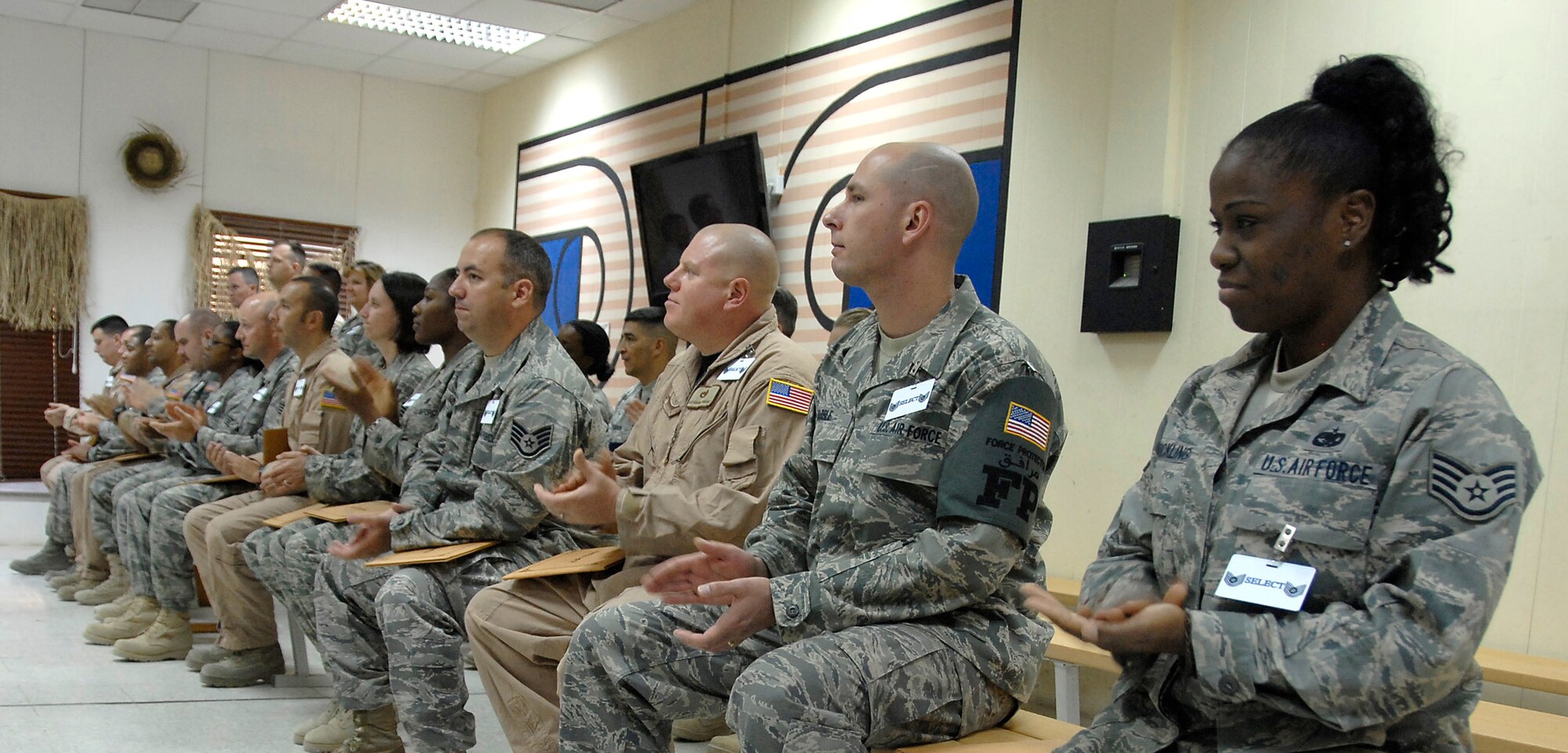 SOUTHWEST ASIA -- A majority of the 67 Airmen recently selected for promotion to master and technical sergeant from the 386th Air Expeditionary Wing listen to Col. Robert Swisher, 386th AEW commander talk about this monumental occasion in their careers and what it means to the Air Force during a ceremony here June 27. (U.S. Air Force photo/Staff Sgt. Patrick Dixon)