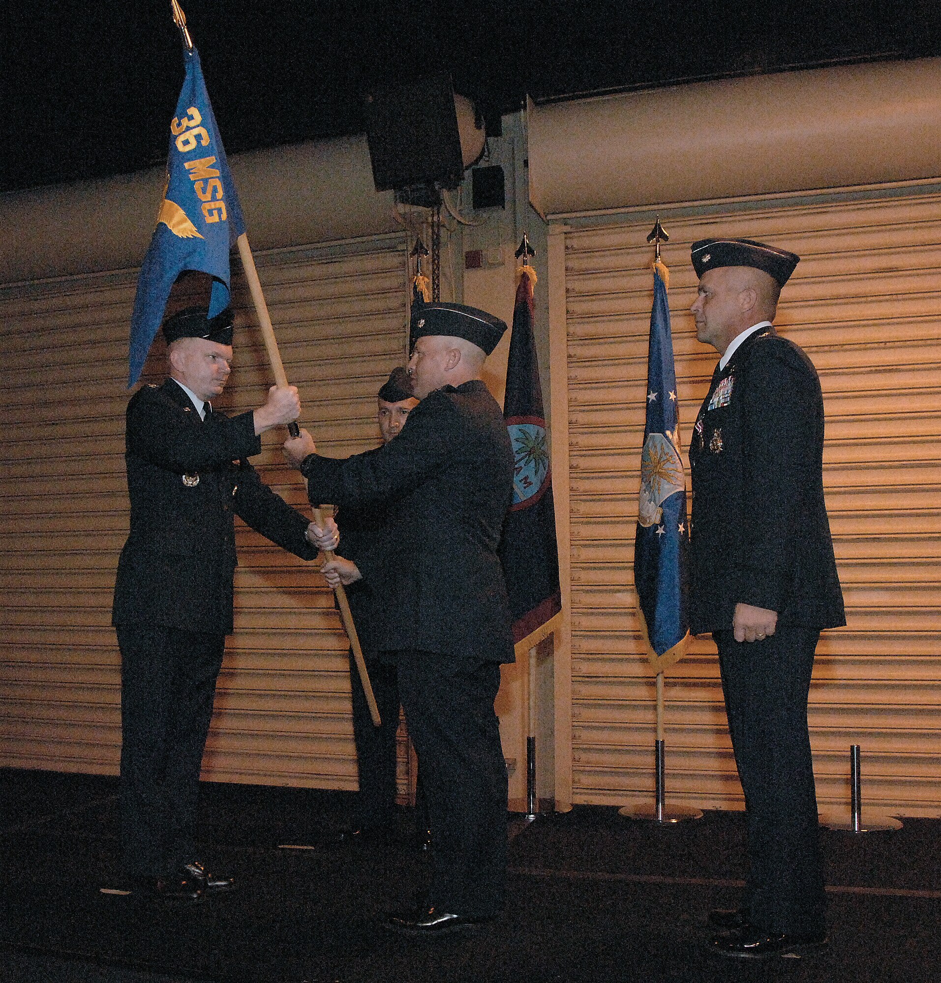 U.S. Air Force Presiding Officer Col. Mark Talley presents the 36th Mission Support Group flag to Lt. Col. Richard Mathews, giving him command of the 36th Civil Engineer Squadron during the Change of Command Ceremony here June 30. Lt. Col. Peter Ridilla has been the Commander of the 36th Civil Engineer Squadron for the past two years and now relinquishes his command to Lieutenant Colonel Mathews. (U.S. Air Force photo by Airman 1st Class Courtney Witt)