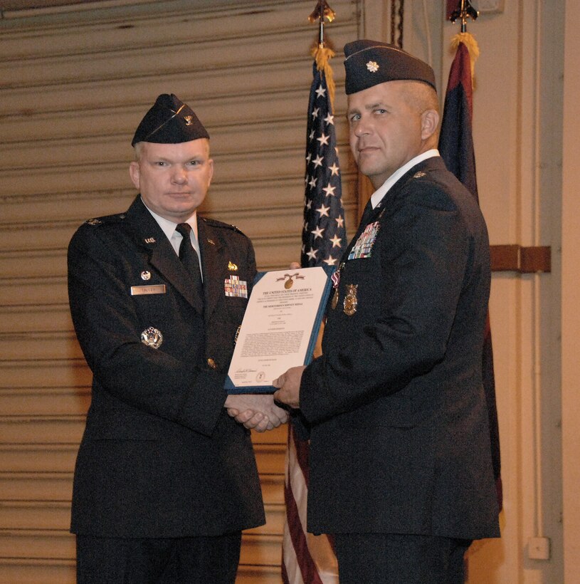 U.S. Air Force Presiding Officer Col. Mark Talley presents Lt. Col. Peter Ridilla  the Meritorious Service Medal during the 36th Civil Engineer Squadron Change of Command Ceremony here June 30. Lieutenant Colonel Ridilla has been the Commander of the 36th Civil Engineer Squadron for the past two years and now relinquishes his command to Lieutenant Colonel Richard Mathews. (U.S. Air Force photo by Airman 1st Class Courtney Witt)