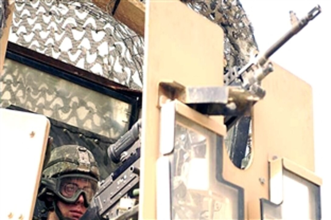 U.S. Army Pfc. Dylan Smith provides security while sitting in the gunner's hatch of his vehicle during an operation in eastern Baghdad, Iraq, June 19, 2008. Smith is assigned to the 10th Mountain Division's 5th Battalion, 25th Field Artillery Regiment, 4th Brigade Combat Team,  Bravo Battery.

