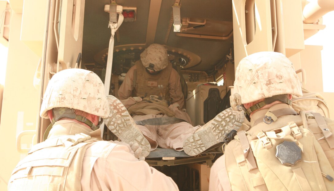 FALLUJAH, Iraq (June 29, 2008) ? Marines with Security Company, Combat Logistics Battalion 1, 1st Marine Logistics Group, prepare to evacuate a simulated casualty during medical evacuation training, June 29. The training required the Marines to evacuate four ?injured? personnel (three of whom were ?unconscious?) with a limited number of vehicles to transport them to Fallujah Surgical. (Photo by Lance Cpl. Cindy G. Alejandrez)