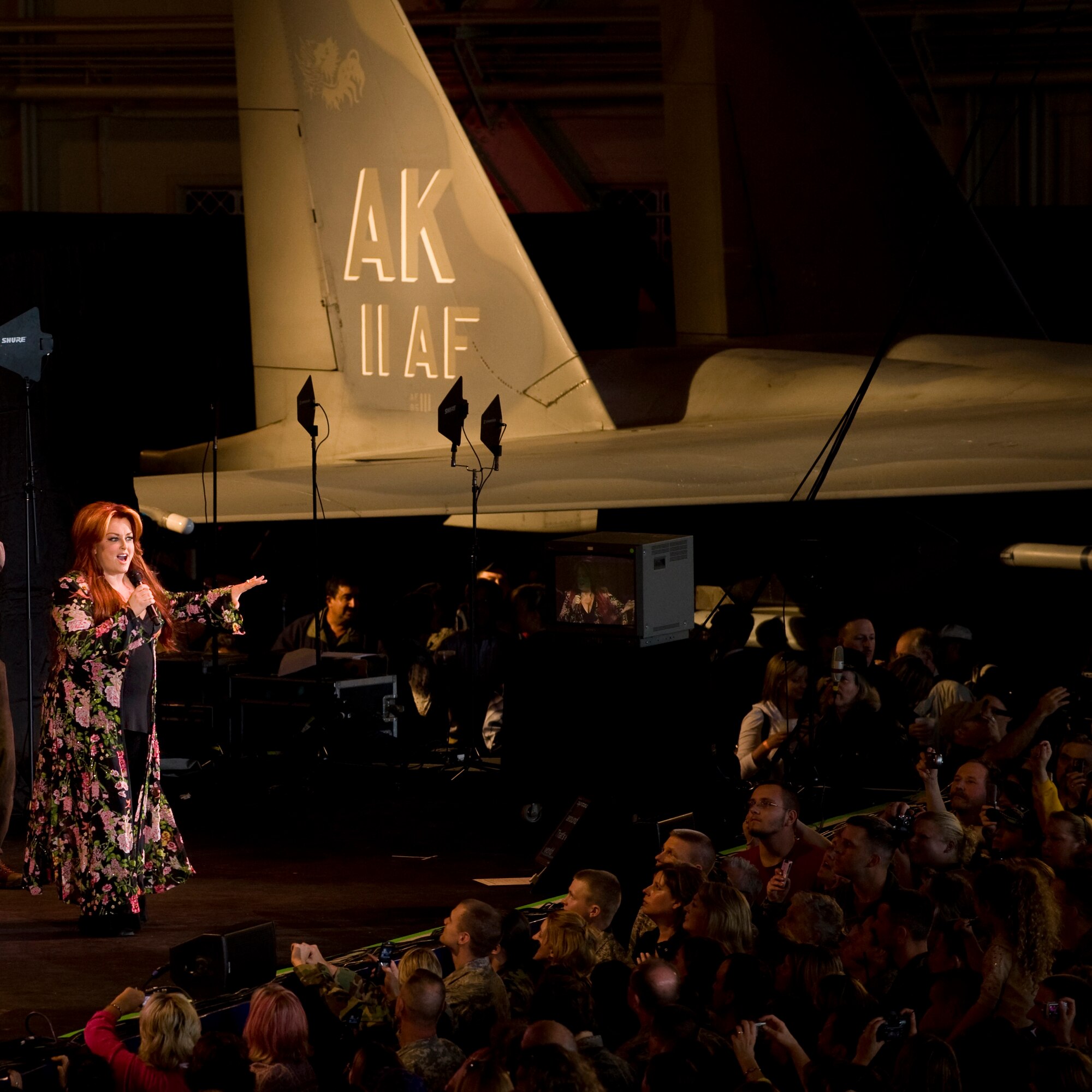 ELMENDORF AIR FORCE BASE, Alaska -- Country Singer Wynonna Judd performs a free concert for the members of the military and Alaska crowd in Hanger 2 during "Alaska's Concert for the Military" June 27, as part of the Alaska's 50th Statehood celebration. (U.S Air Force photo byTech. Sgt. Alan Port)