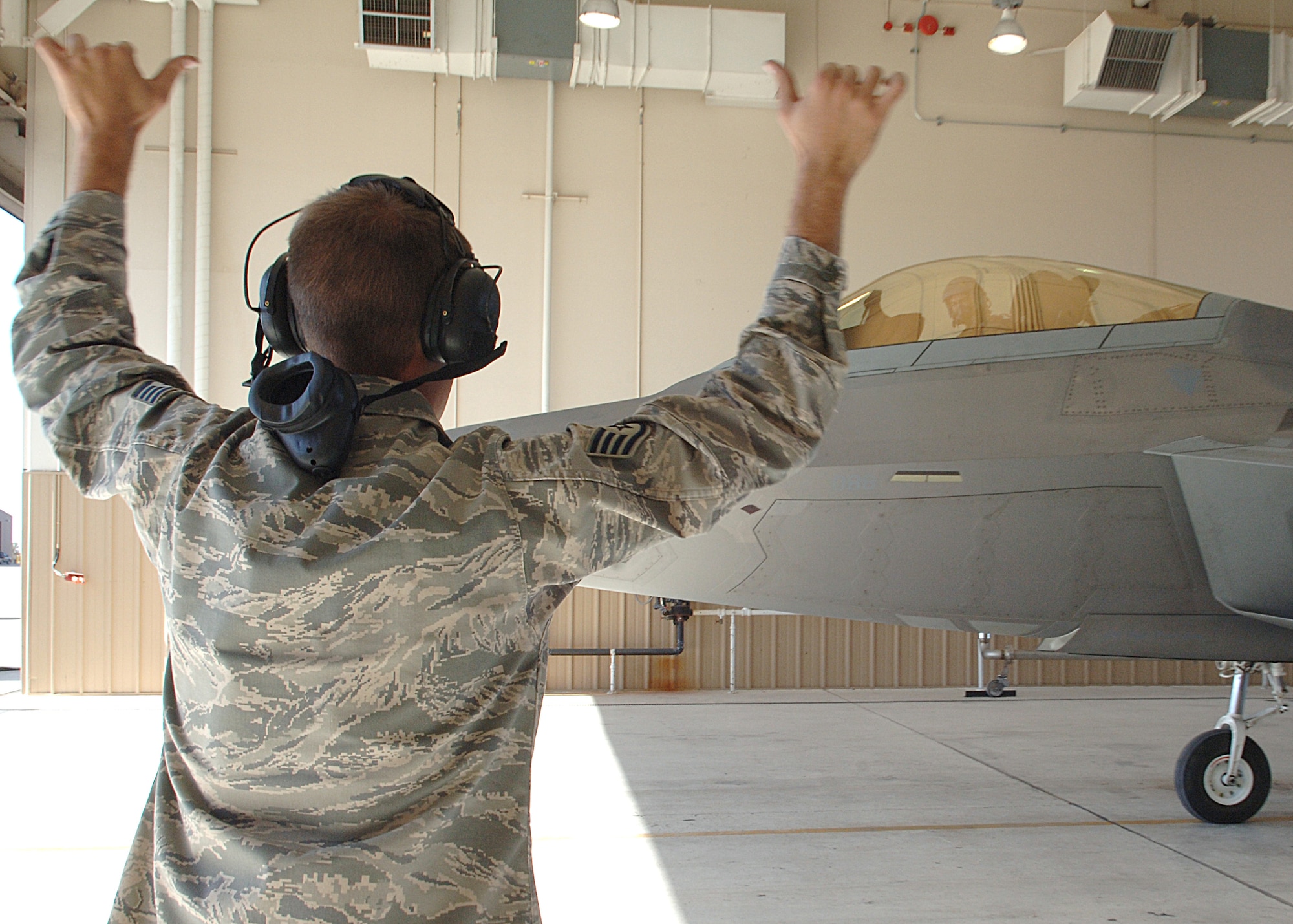 Staff Sgt. John Bryan, 49th Aircraft Maintenance Squadron taxis in Col. Jeff Harrigian, 49th Fighter Wing commander, into a hangar at Holloman Air Force Base, N.M.  (U.S. Air Force photo/Airman 1st Class John Strong) 
  