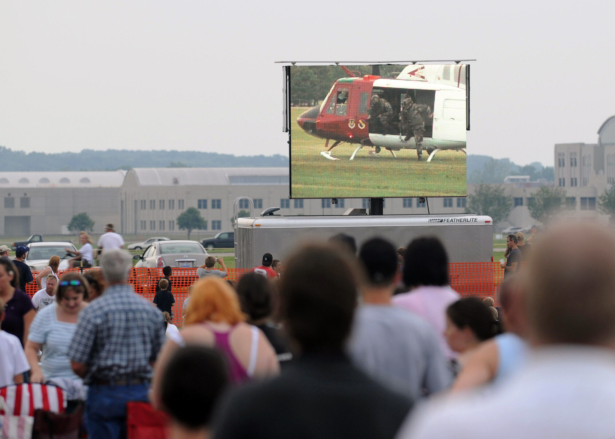 A crowd watches as a UH-1 Huey performs a mission scenario during the 4th annual Freedom's Call Tattoo June 27 on the grounds of the National Museum of the U.S. Air Force in Dayton, Ohio. More than 75,000 peole came out for the event that consisted of aircraft fly overs, food and music by the Air Force Band of Flight, Charlie Daniels Band and local performers. The UH-1 is from Eglin Air Force Base, Fla. (U.S. Air Force photo/Staff Sgt Joshua Strang) 
