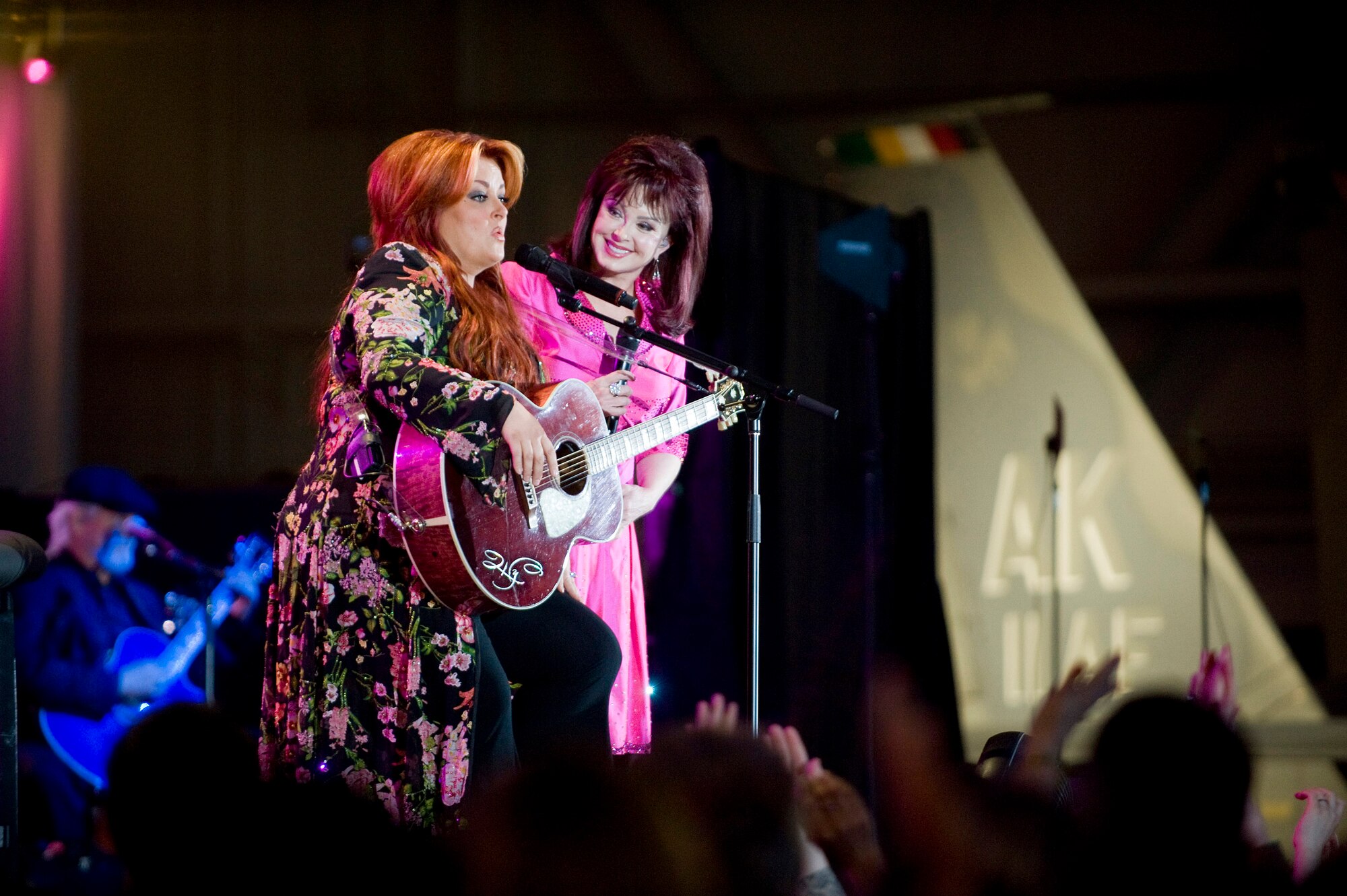 Wynonna and Naomi Judd sing together before the military and Alaskan crowd at the Alaska's Operation Gratitude concert June 27 at Elmendorf Air Force Base, Alaska. The concert was a part of Alaska's 50 years of statehood celebration. (U.S. Air Force photo/Senior Airman Jonathan Steffen) 